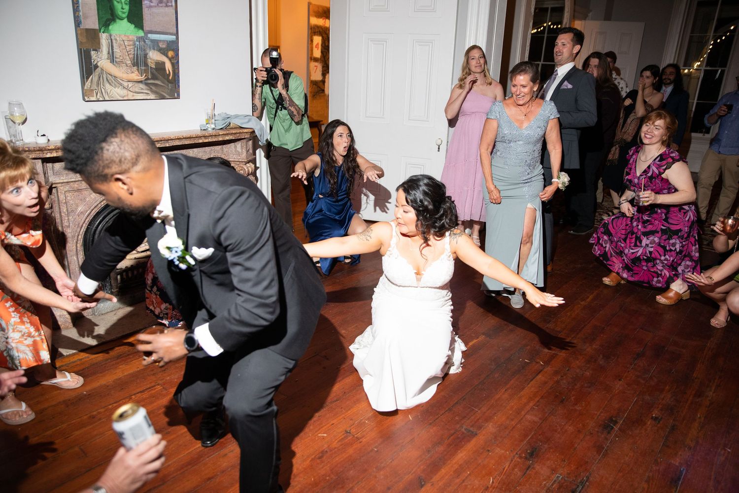 Wedding guests dancing and celebrating on a dance floor at a reception party.