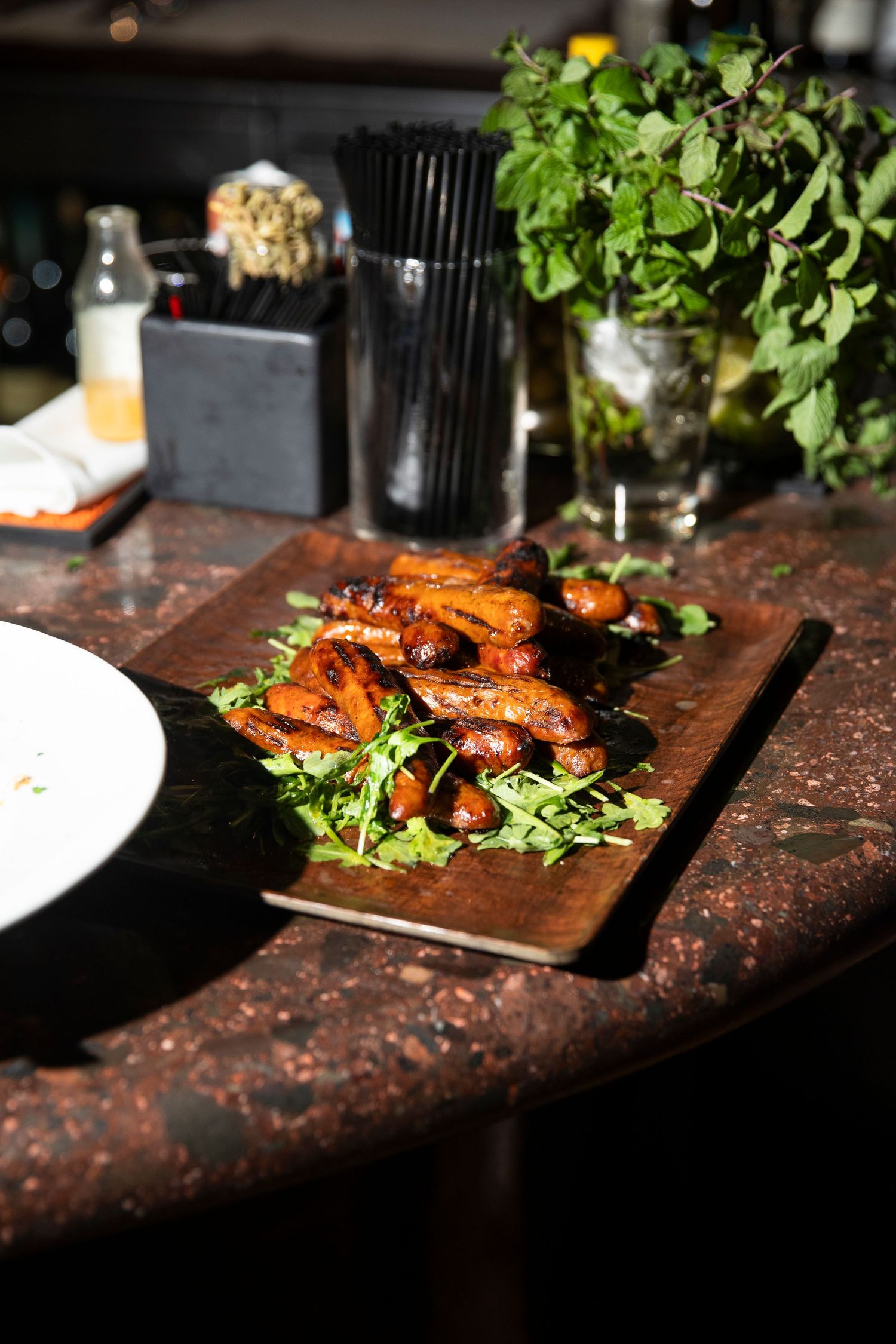Grilled chicken wings served on wooden boards with fresh garnish.
