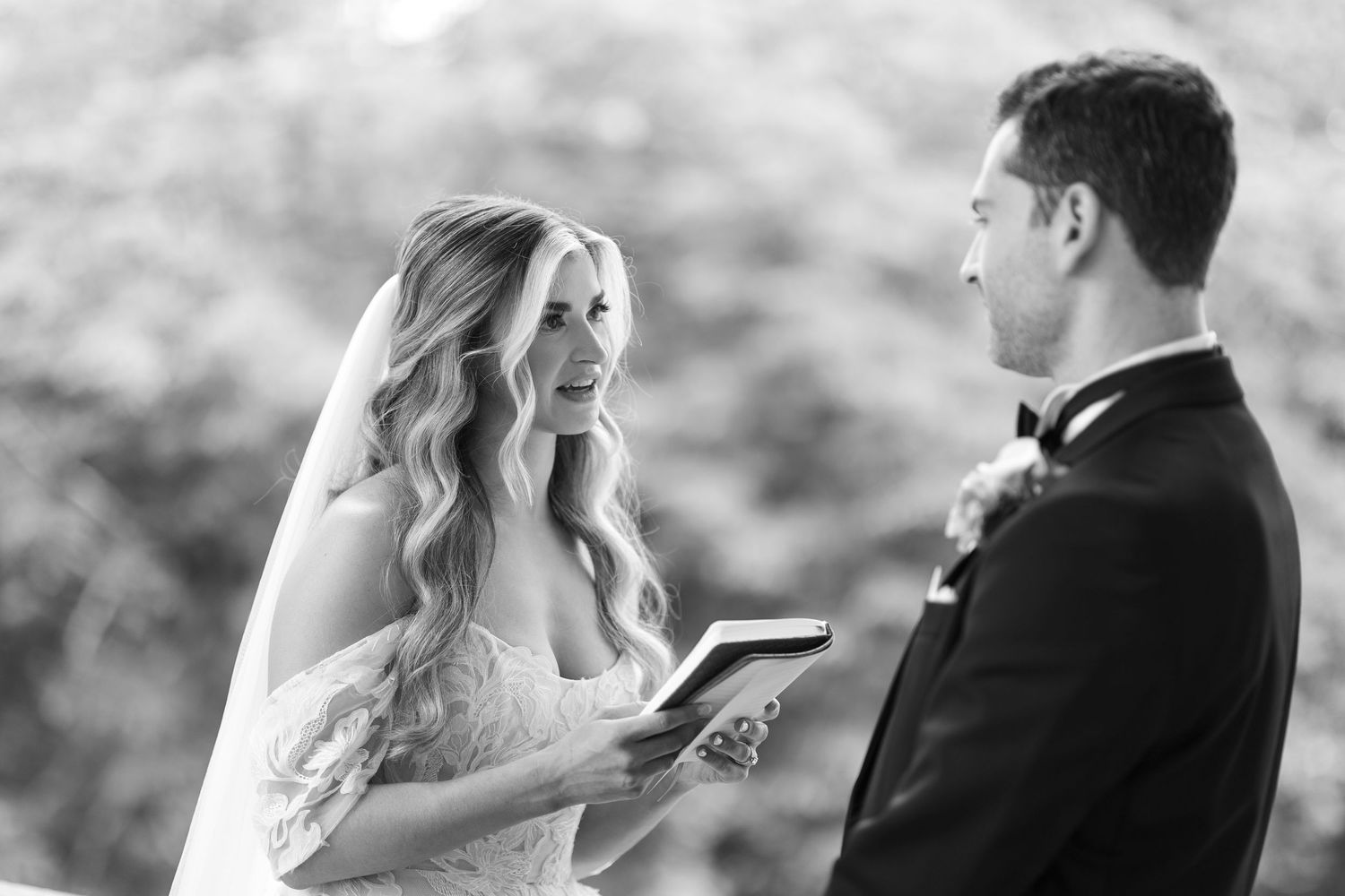 Black and white outdoor wedding portraits capturing intimate first look reactions.