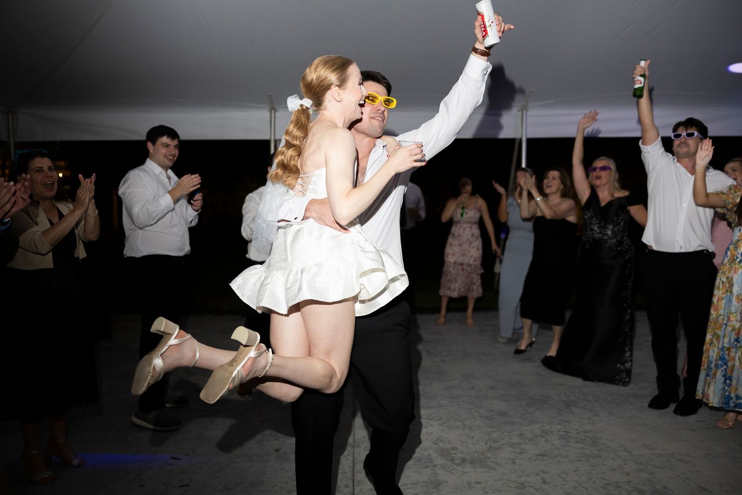 Couples dancing together at a dimly lit wedding reception.