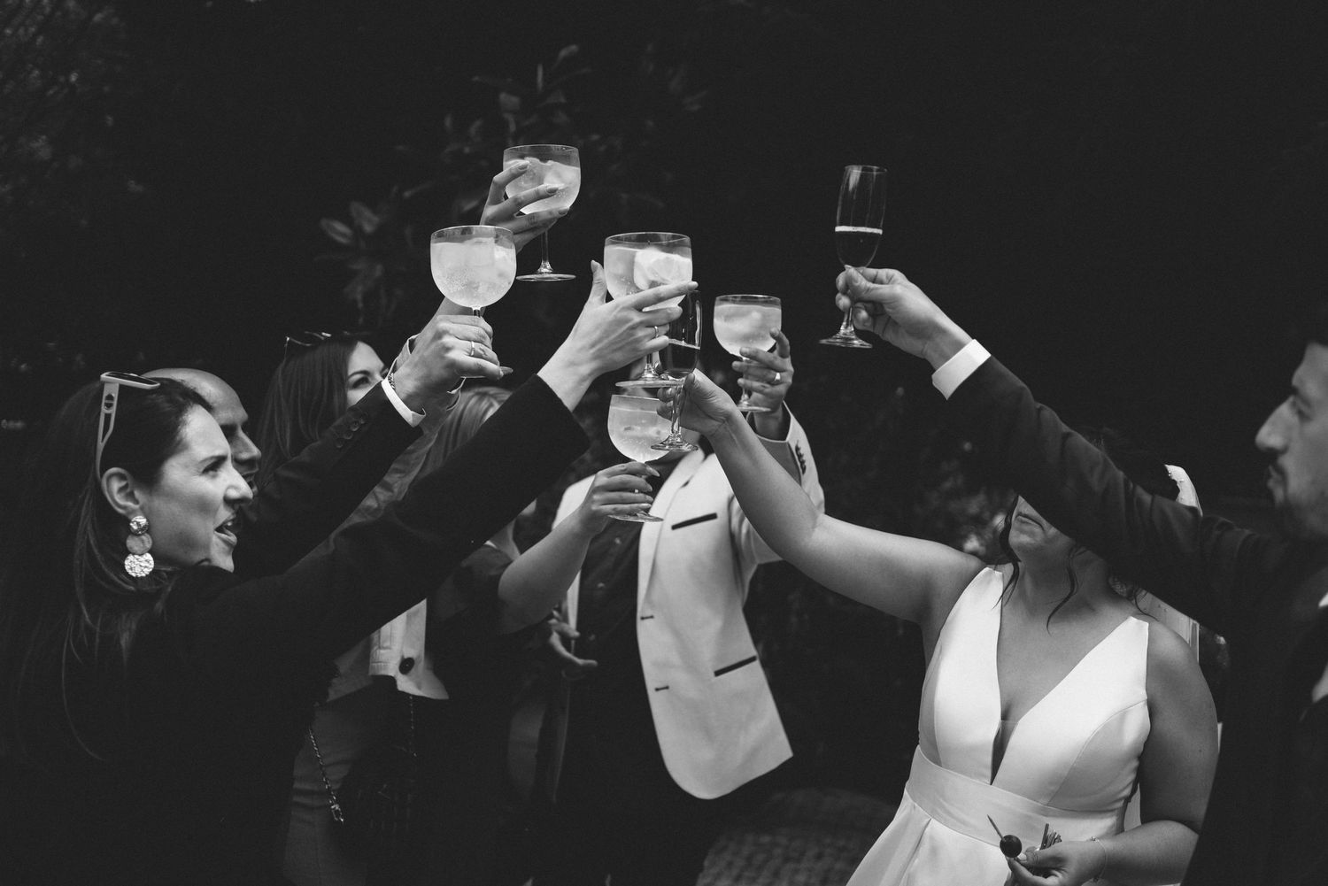 Bride and groom raising their glasses with wedding guests during an elegant reception in Portugal