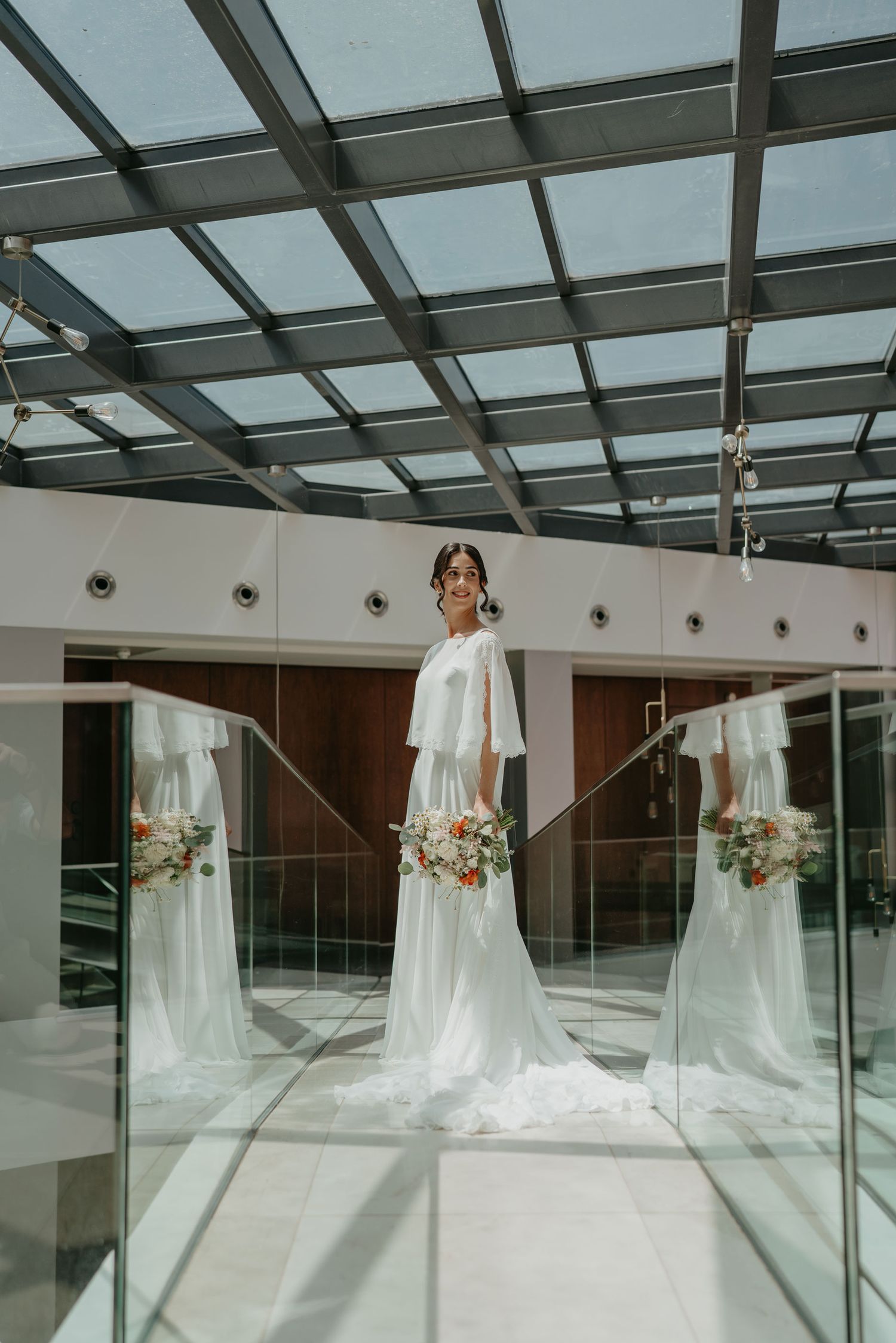 Bride in wedding dress surrounded by reflections before the ceremony