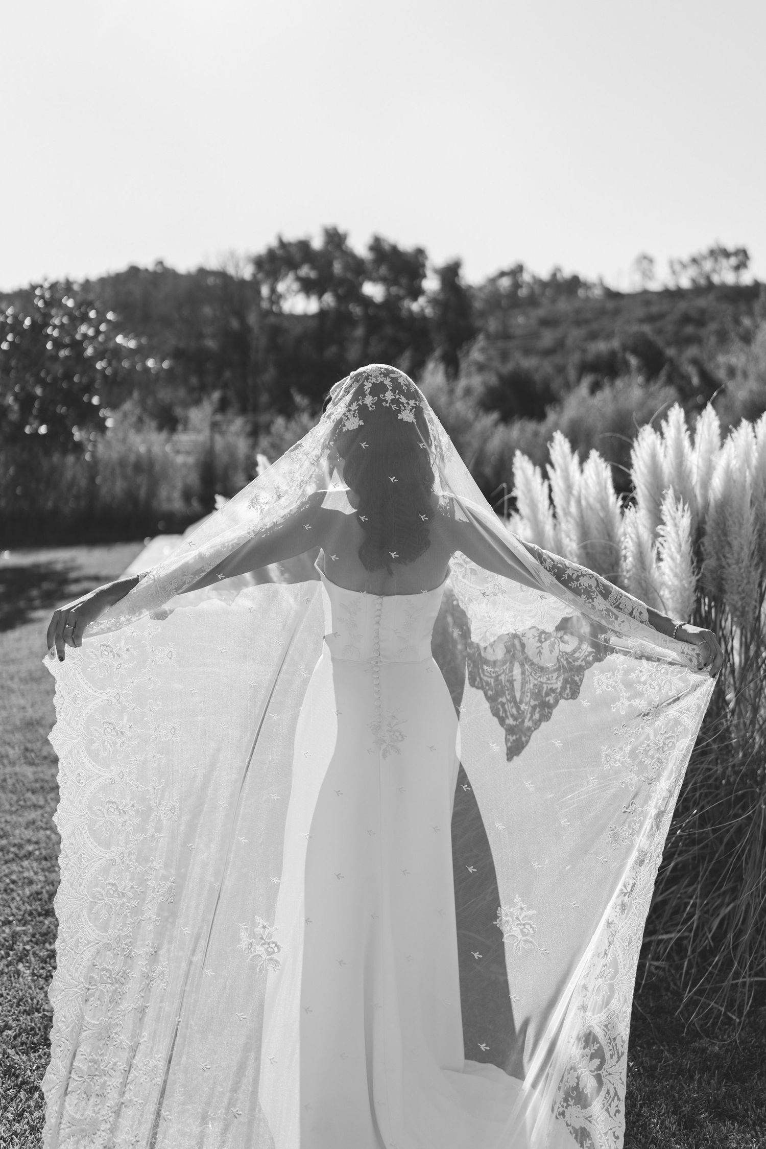 Bride holding her flowing wedding dress