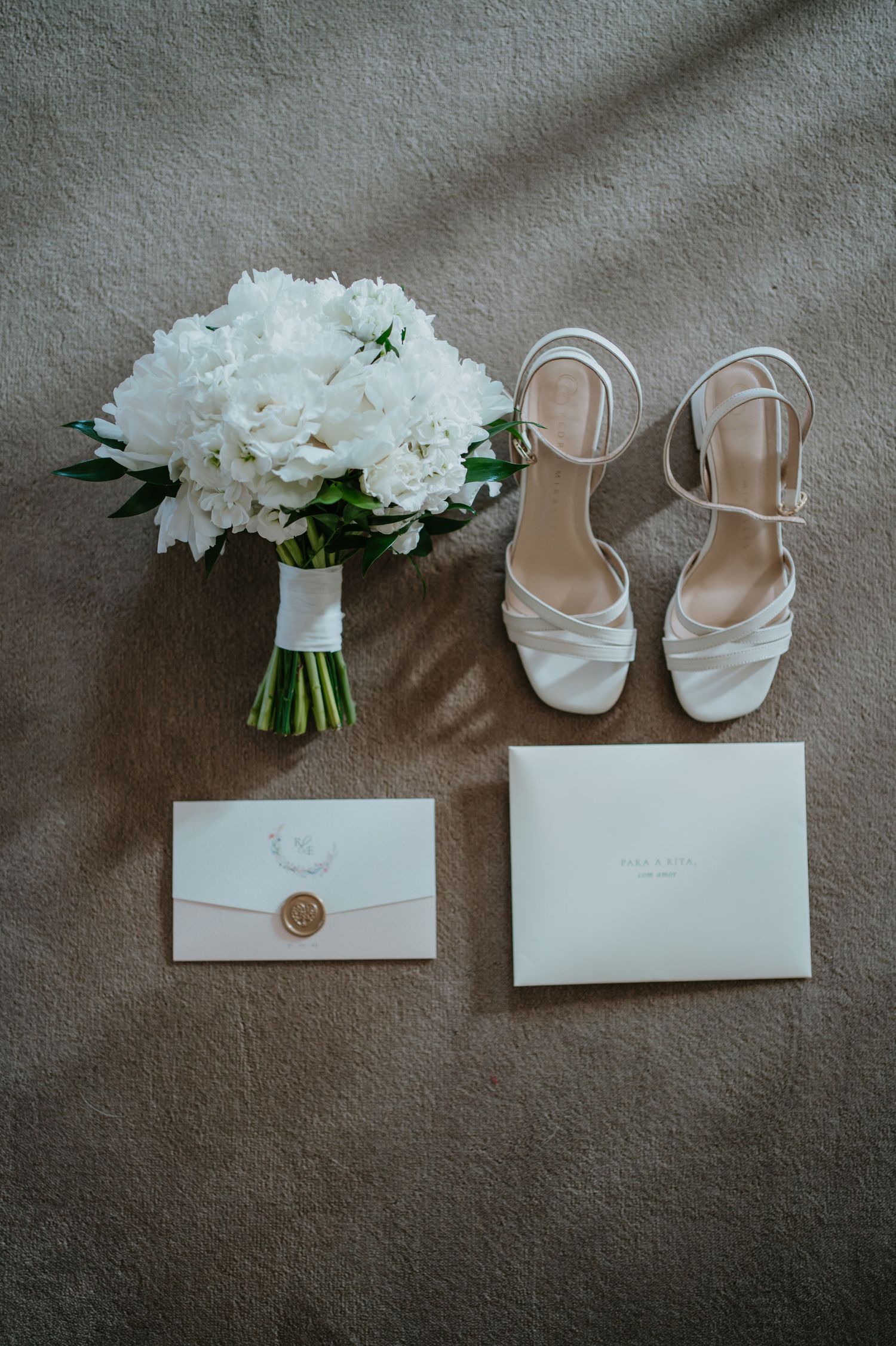 Bridal details with wedding shoes, white bouquet and stationary in Portugal