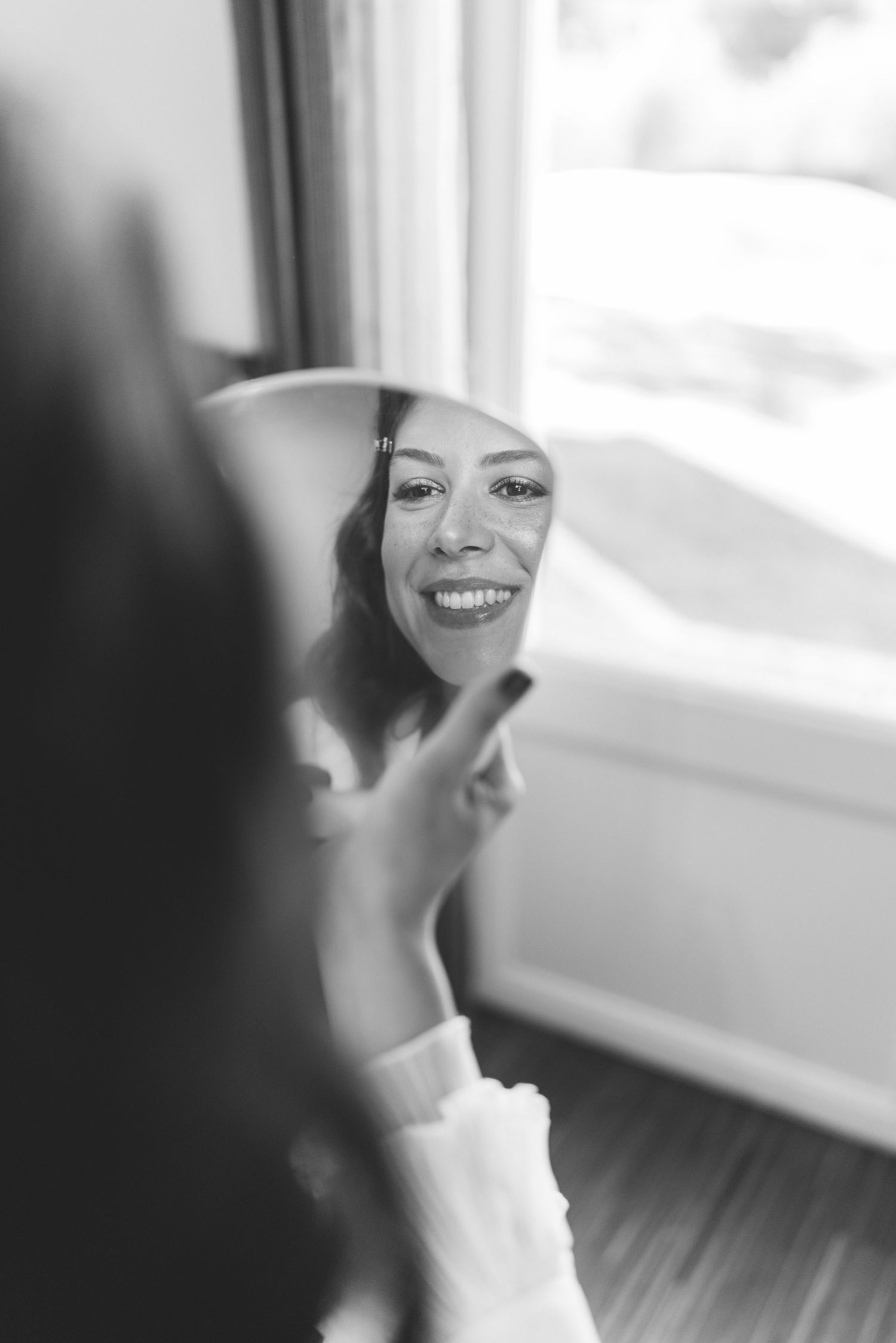 Emotional black and white moment of a bride during her wedding preparations