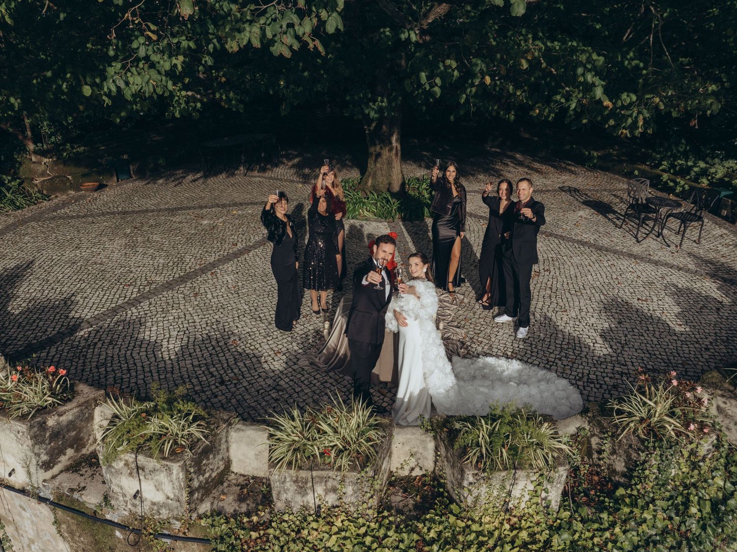Bride and groom celebrating with their wedding party at Camélia Gardens in Sintra, Portugal