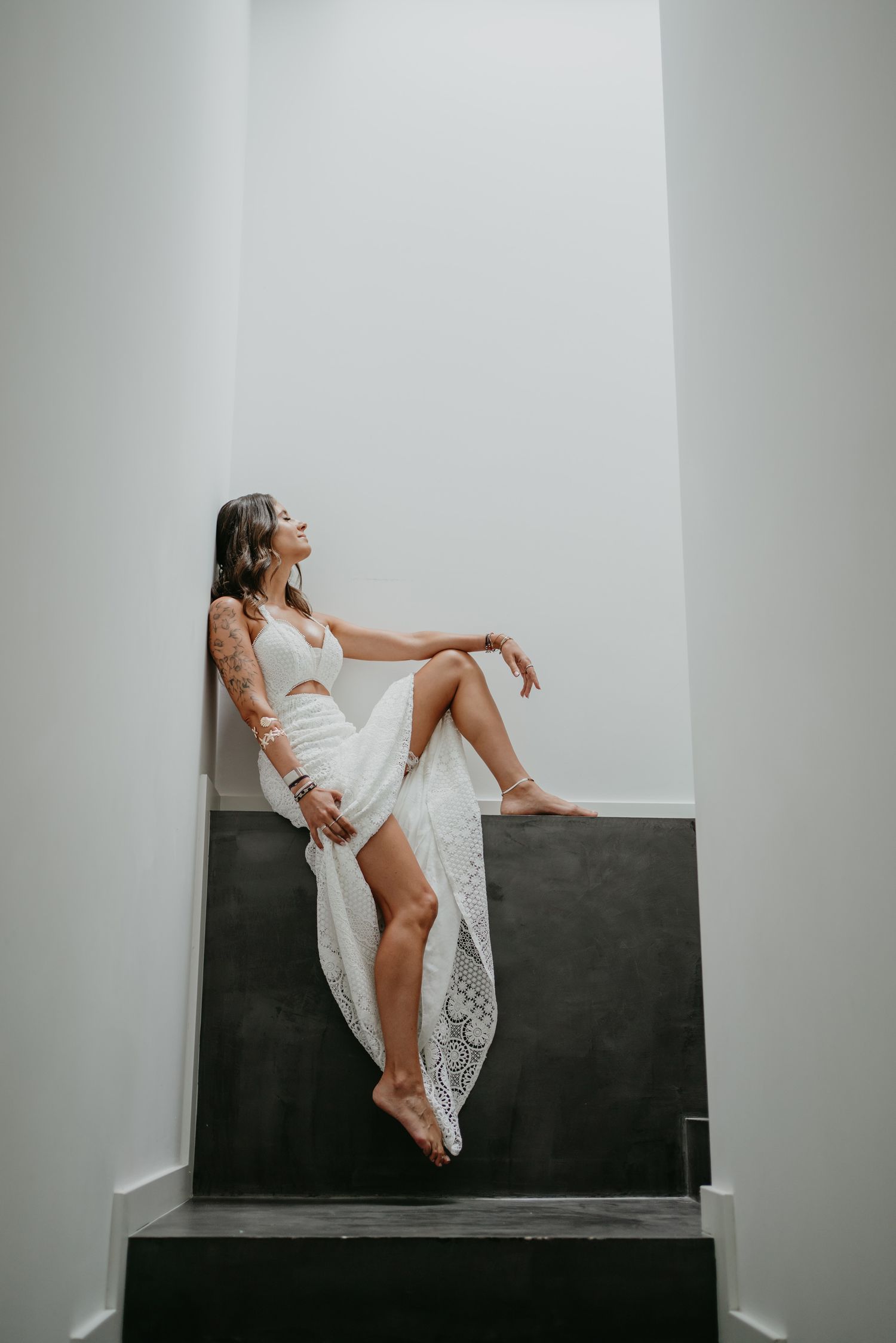 Elegant bride seated in a minimalist setting before her wedding ceremony in Portugal