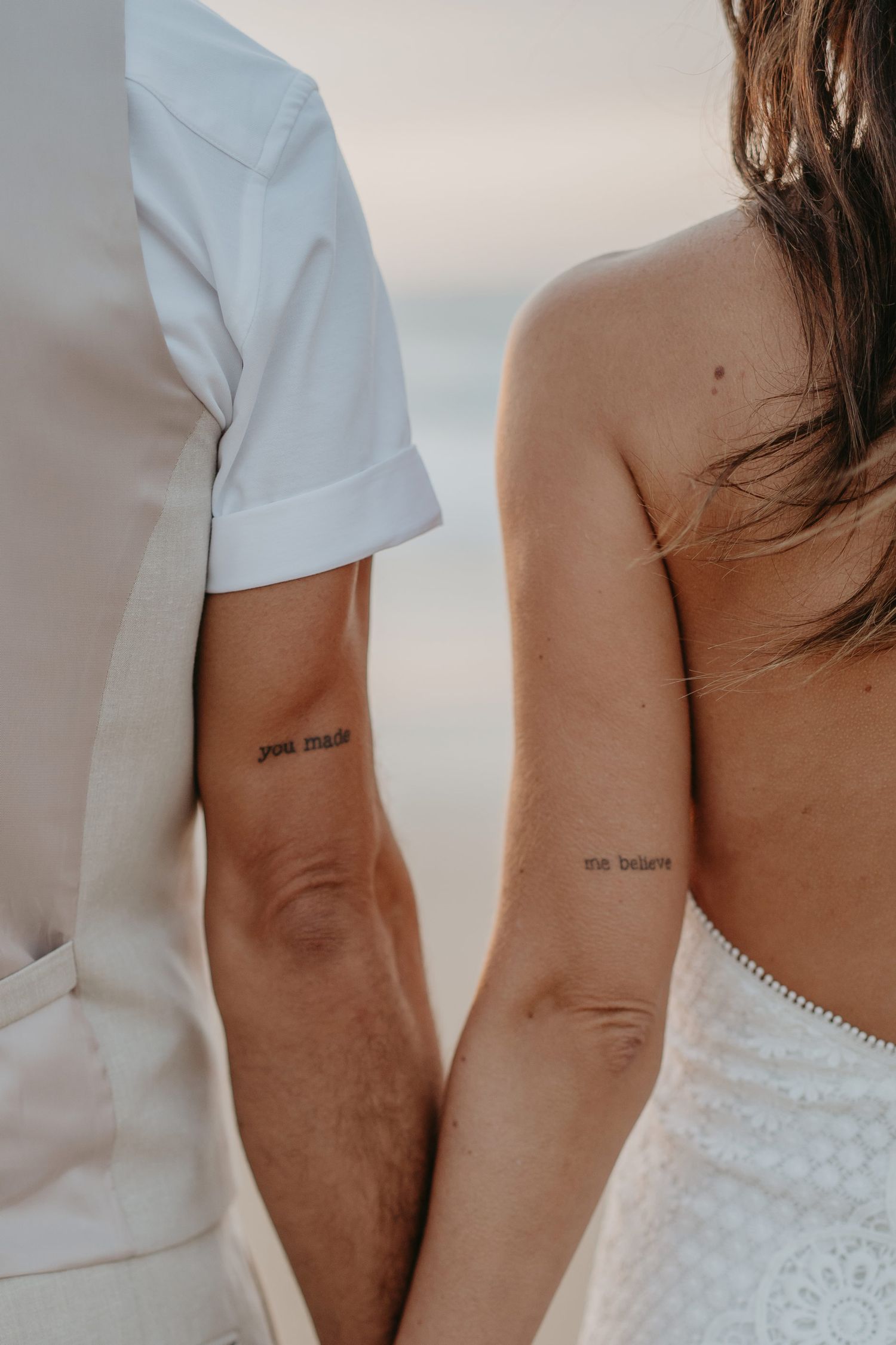 Intimate detail of bride and groom holding hands on their wedding day