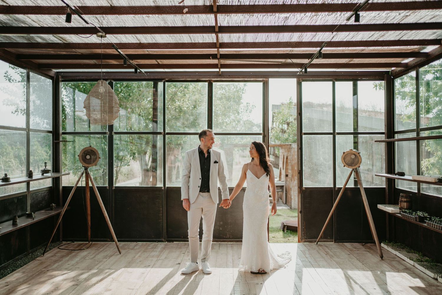 Bride and groom inside the greenhouse at Rio do Prado in Óbidos