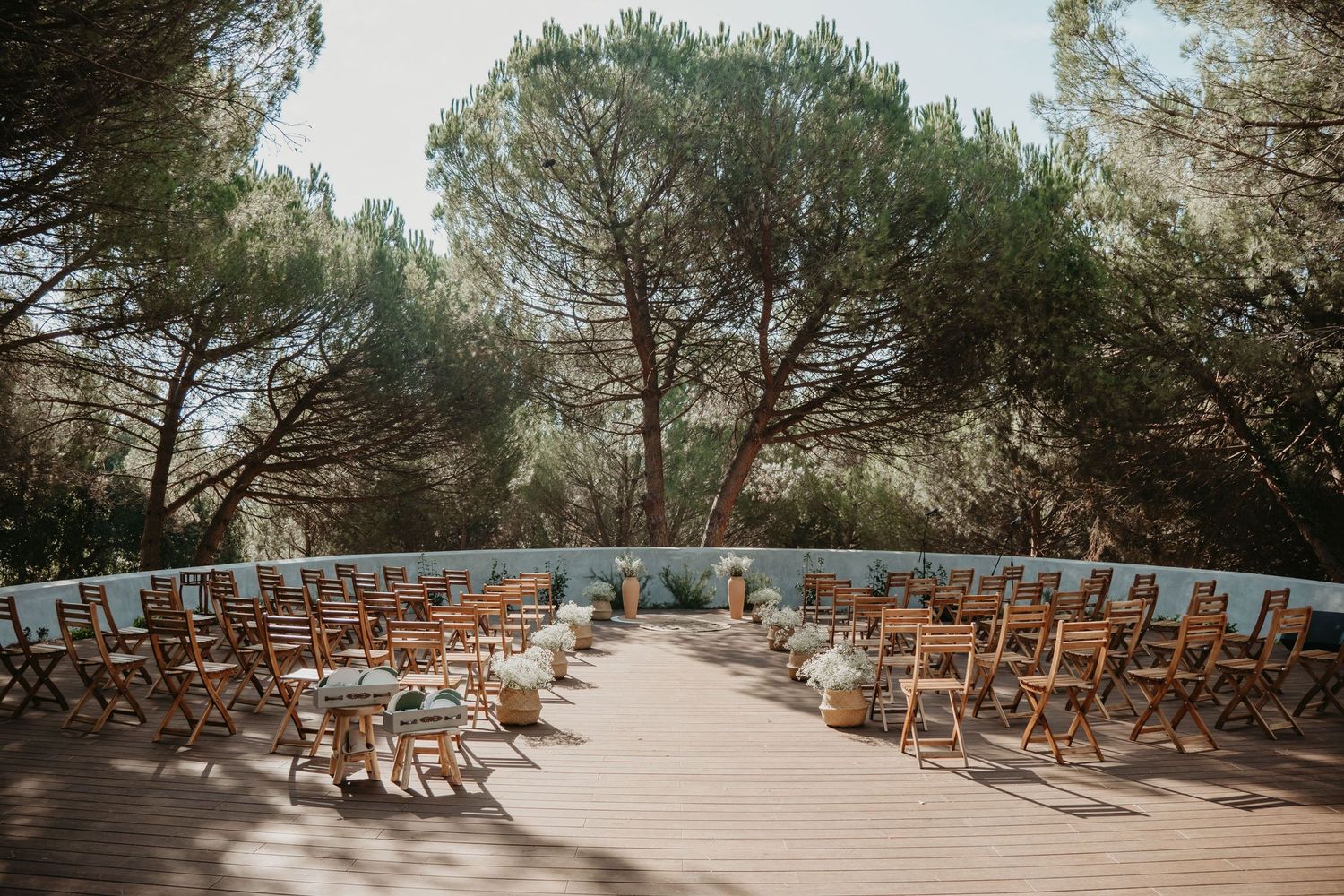 Outdoor wedding ceremony setting surrounded by pine trees in Portugal
