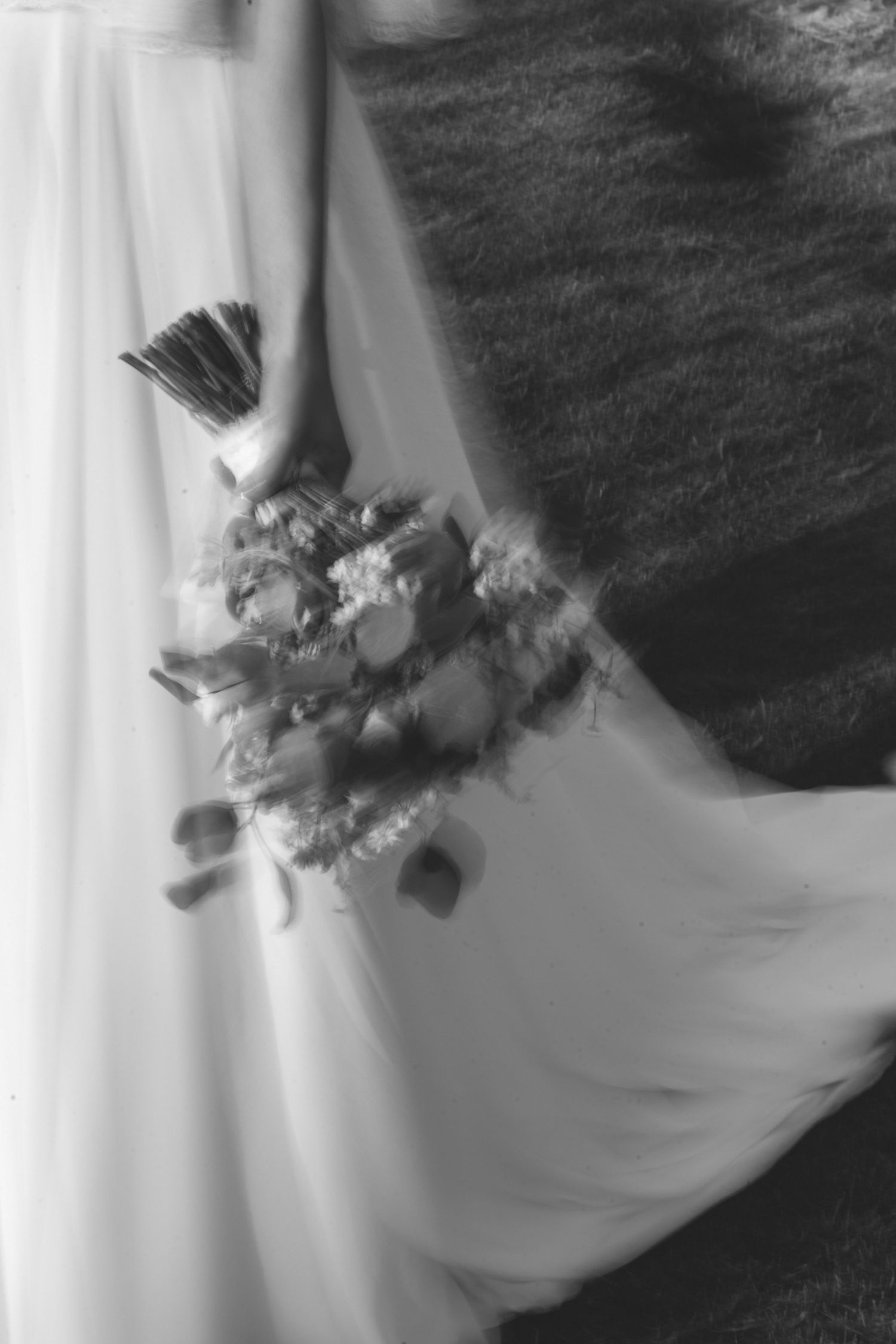 Black and white detail of a bride holding her wedding bouquet