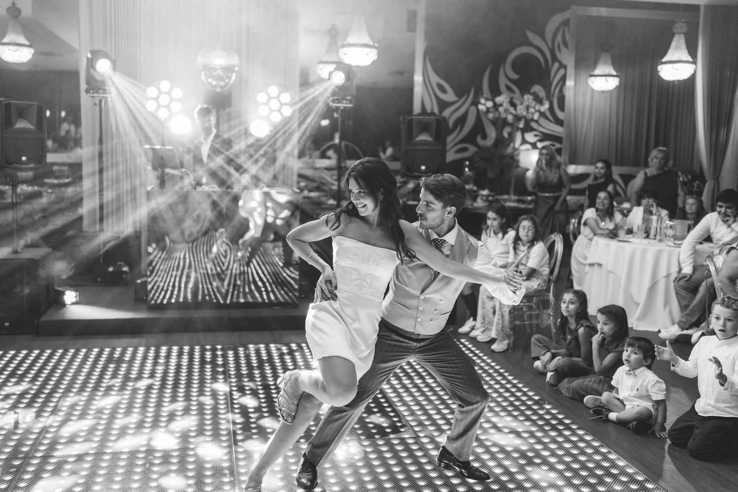 Black and white photograph of newlyweds dancing at their wedding reception