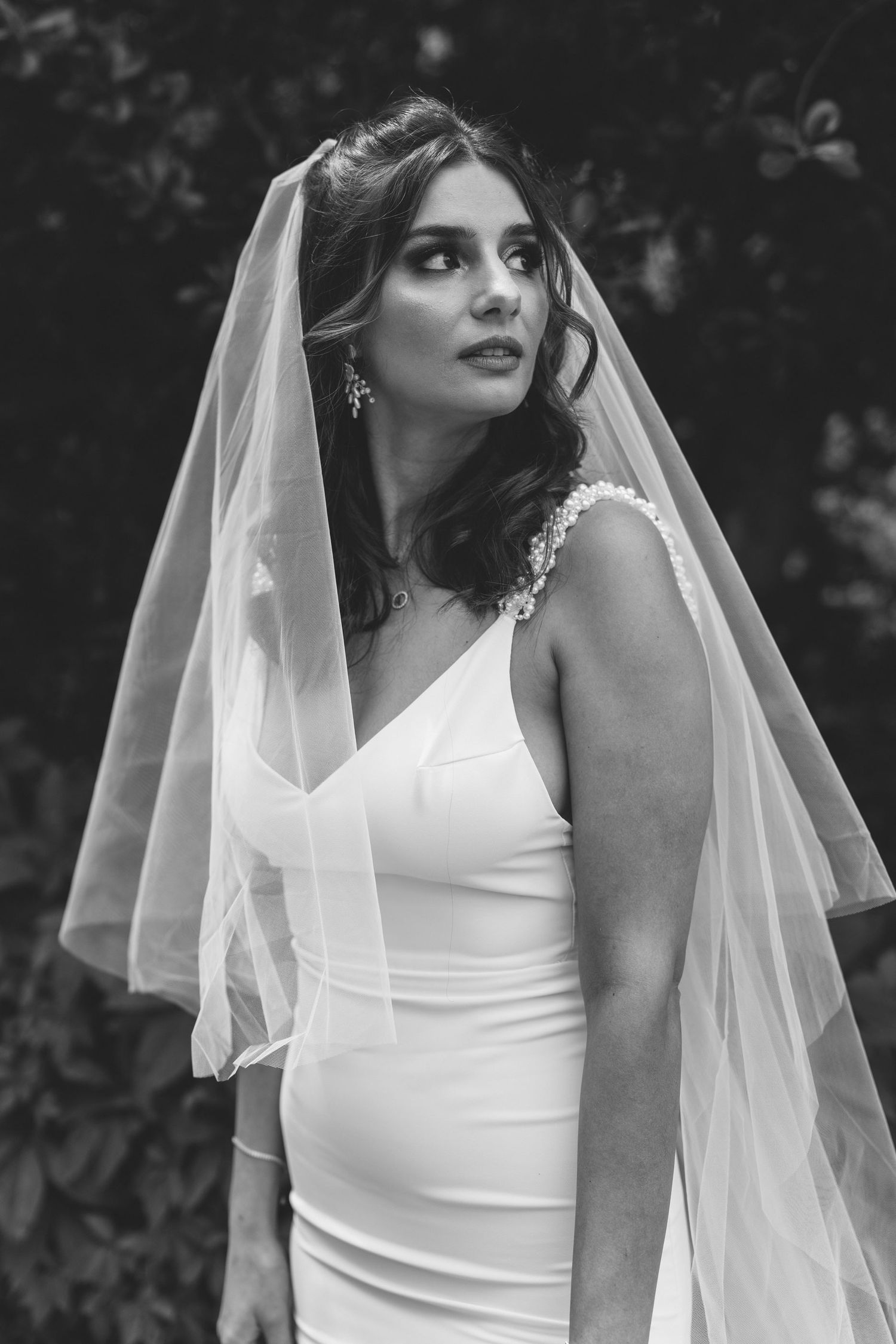 Timeless black and white portrait of a bride wearing her wedding veil