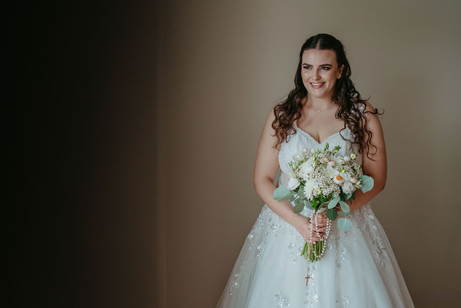 Elegant bridal portrait holding a delicate wedding bouquet in Portugal
