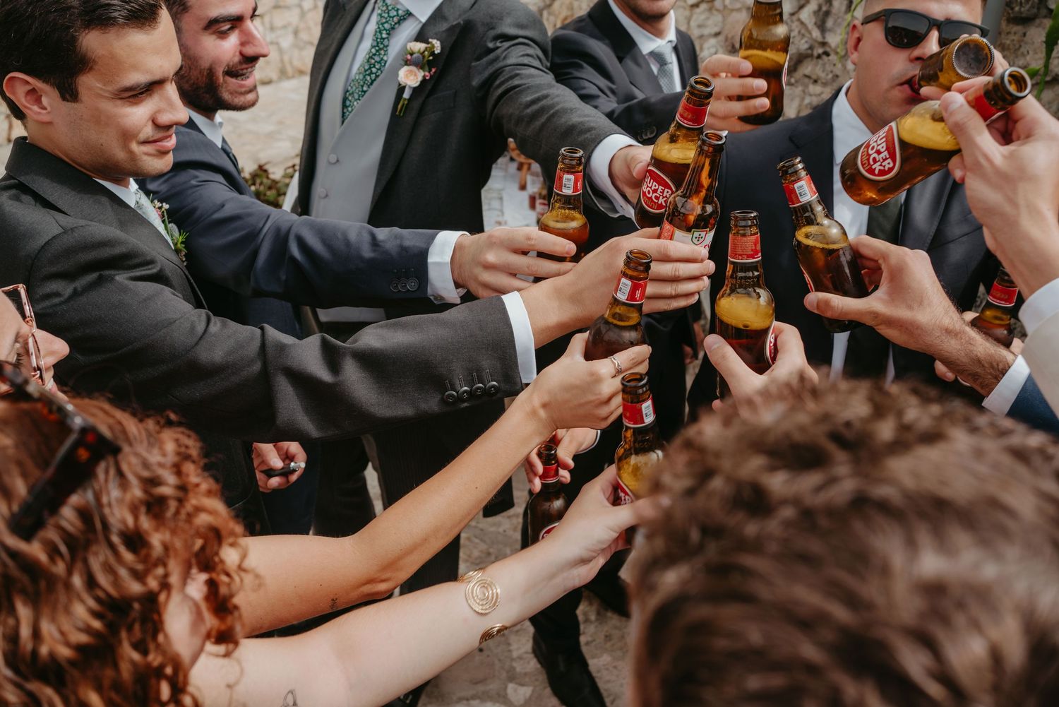 Wedding guests raising their drinks in a joyful celebration