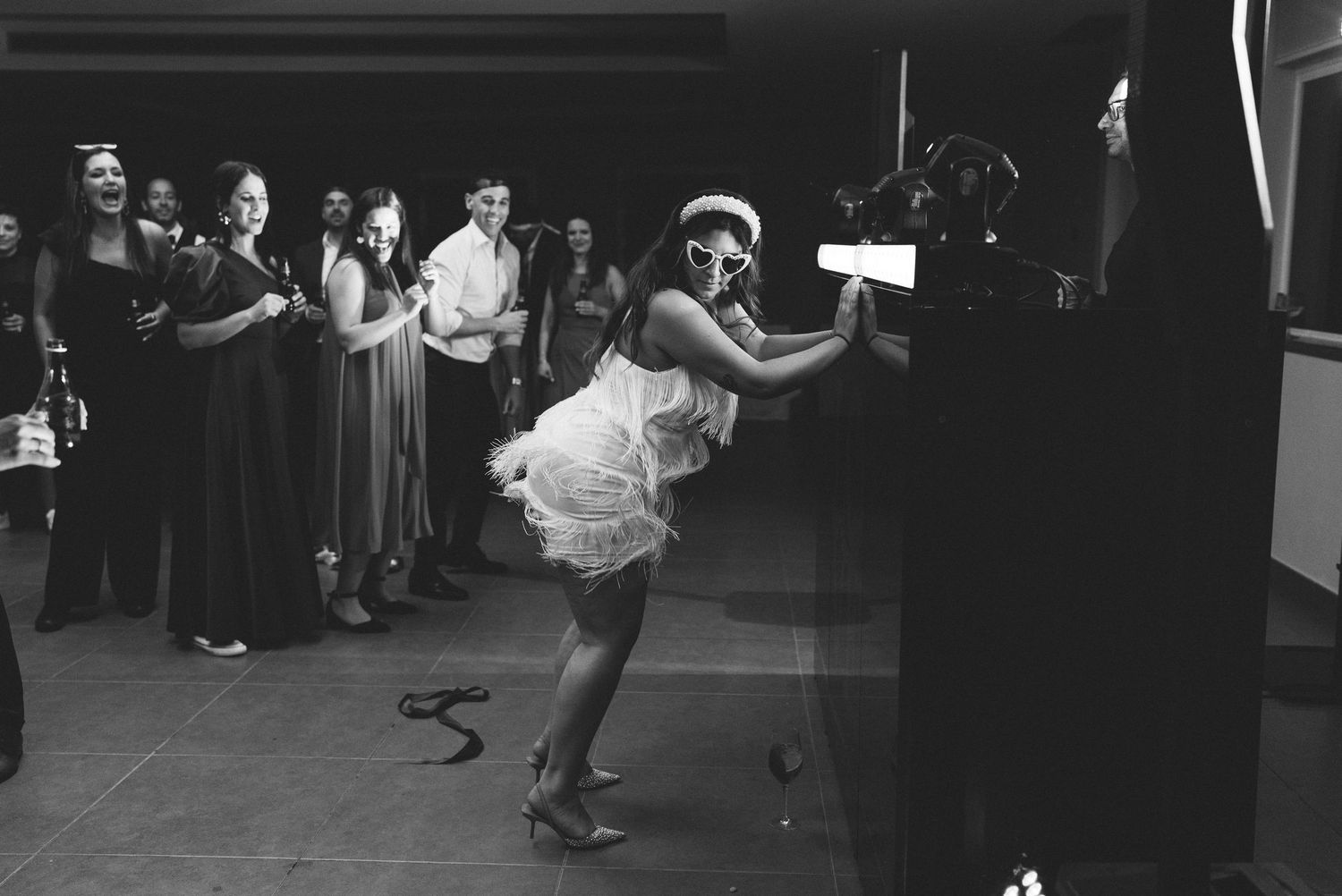 Candid black and white photo of the bride celebrating on the dance floor at her wedding