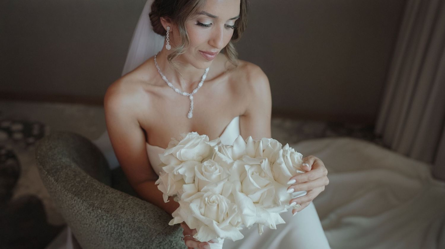 Bride holding statement floral bouquet during wedding preparations in Portugal