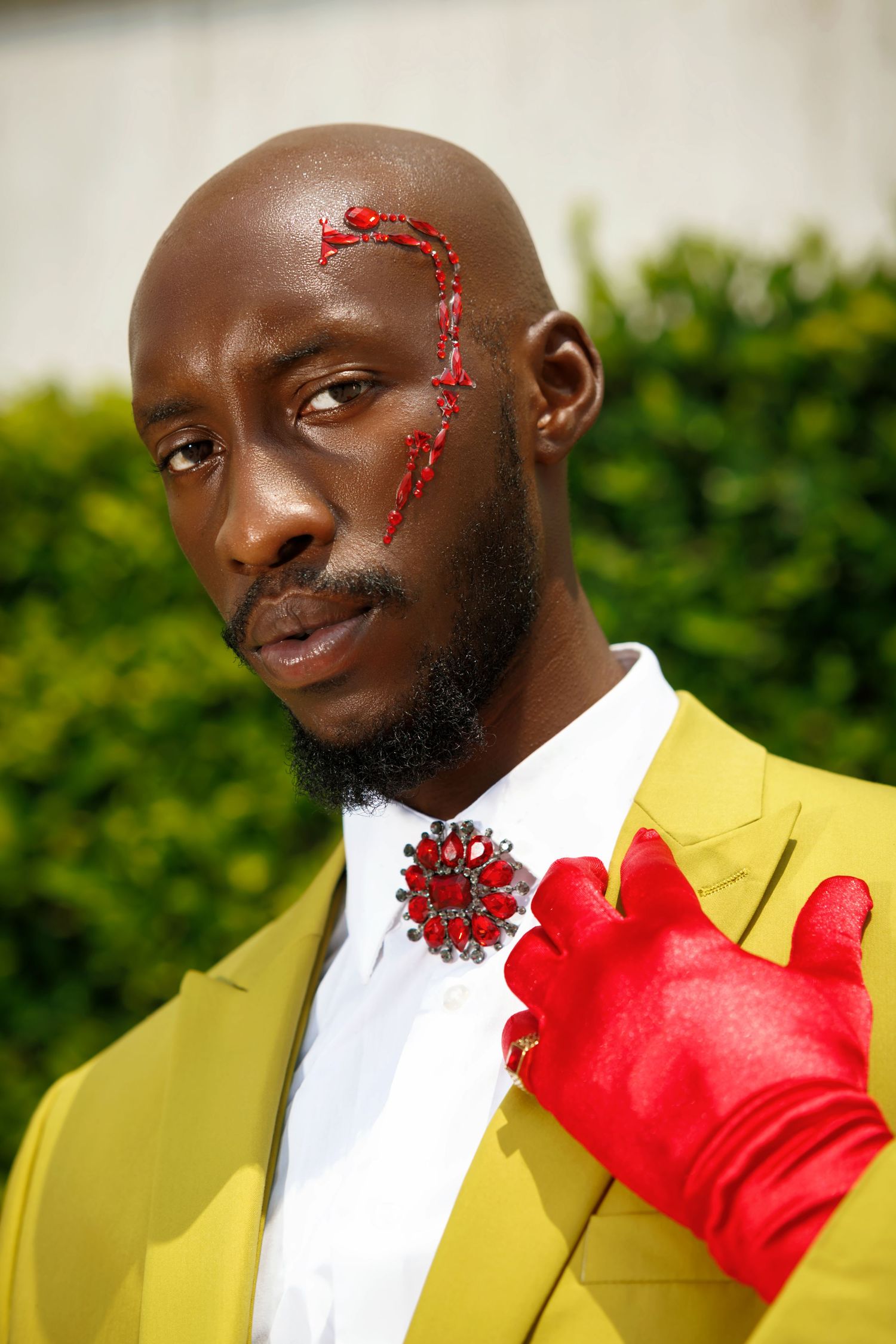 Fashion portrait in yellow suit with red gloves and decorative face art. by Beoncia Dunn