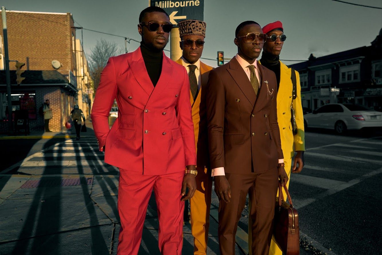 Three people in vibrant suits walking down an urban street at sunset.PZ STUDIO VISUALS