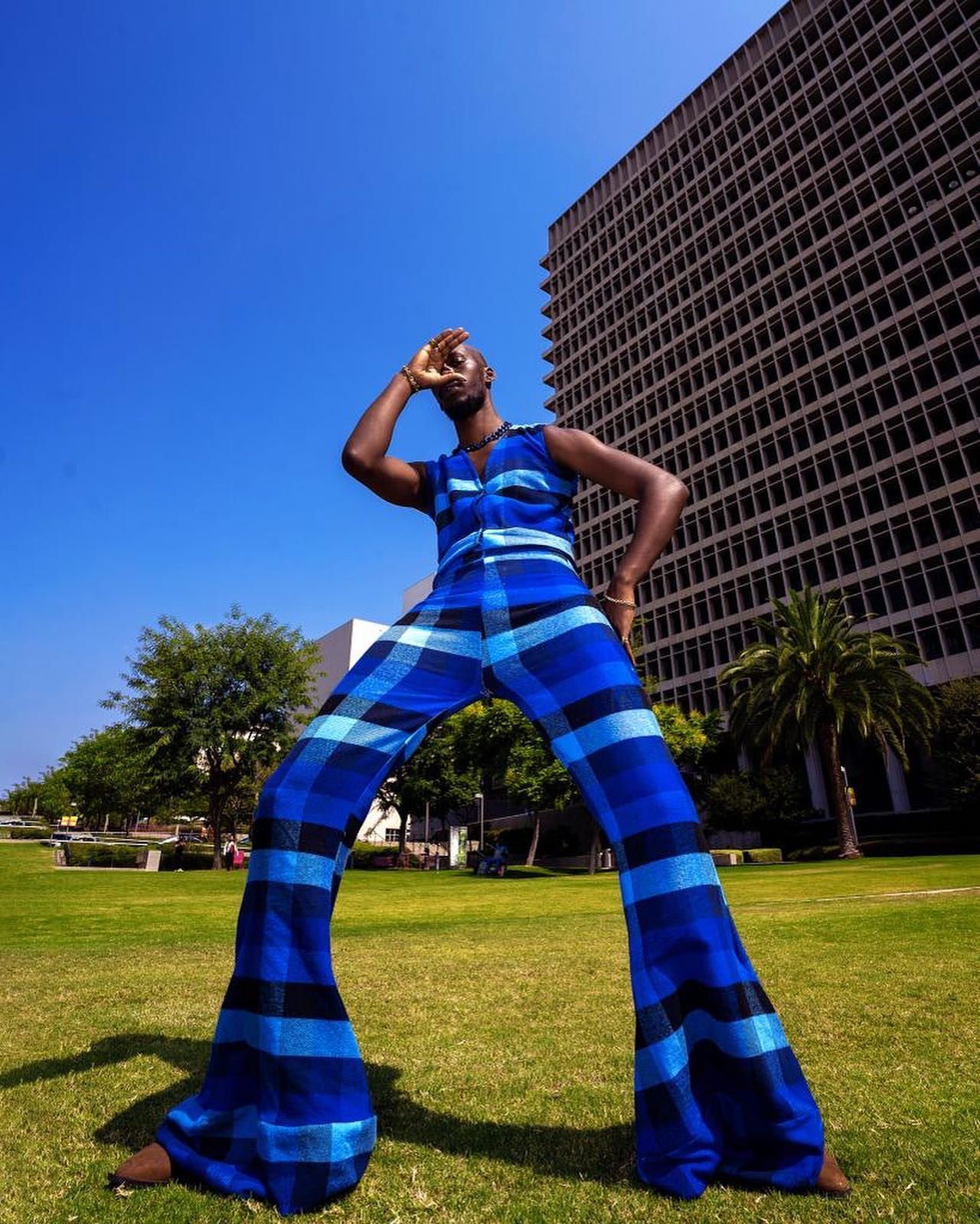 Artistic dance movements captured in a vibrant blue outfit against an urban landscape. Jonathan Kalema PZ STUDIO VISUALS