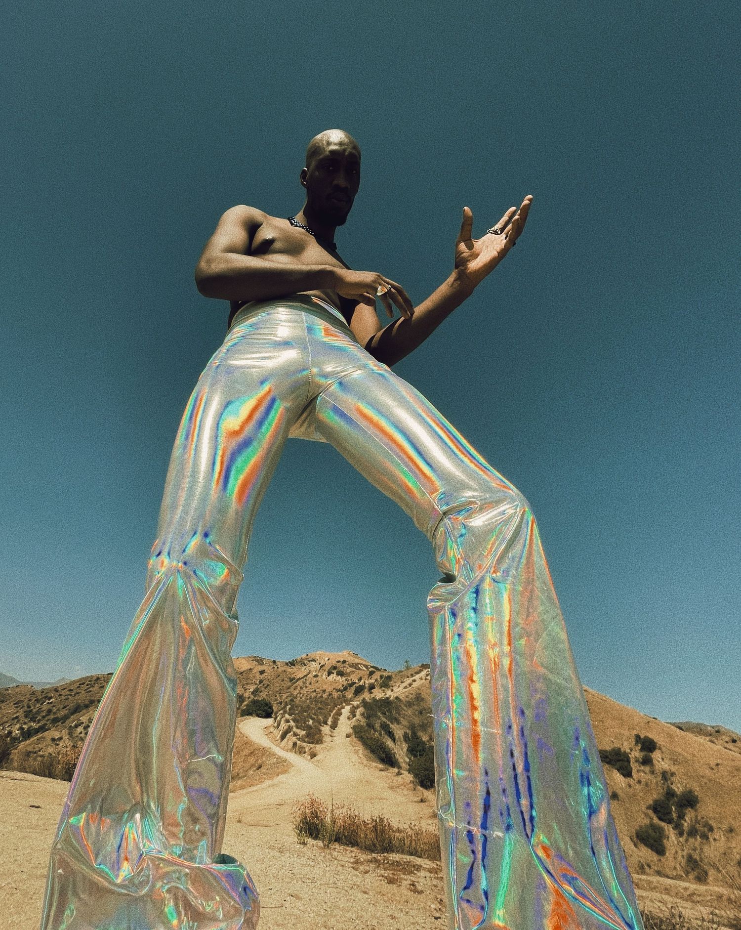 Flowing iridescent fabric catches light in desert landscape choreography.PZ STUDIO VISUALS  x Beoncia Dunn