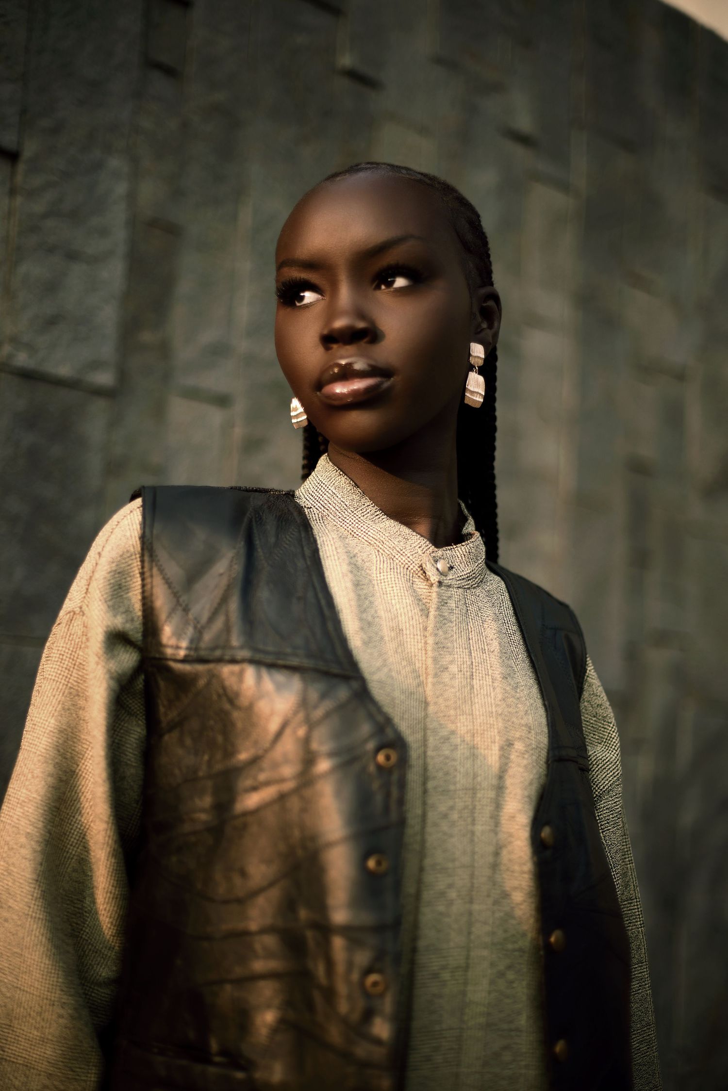 Dramatic portrait sequence showing subject in light colored outfit against dark textured background. PZ STUDIO VISUALS
