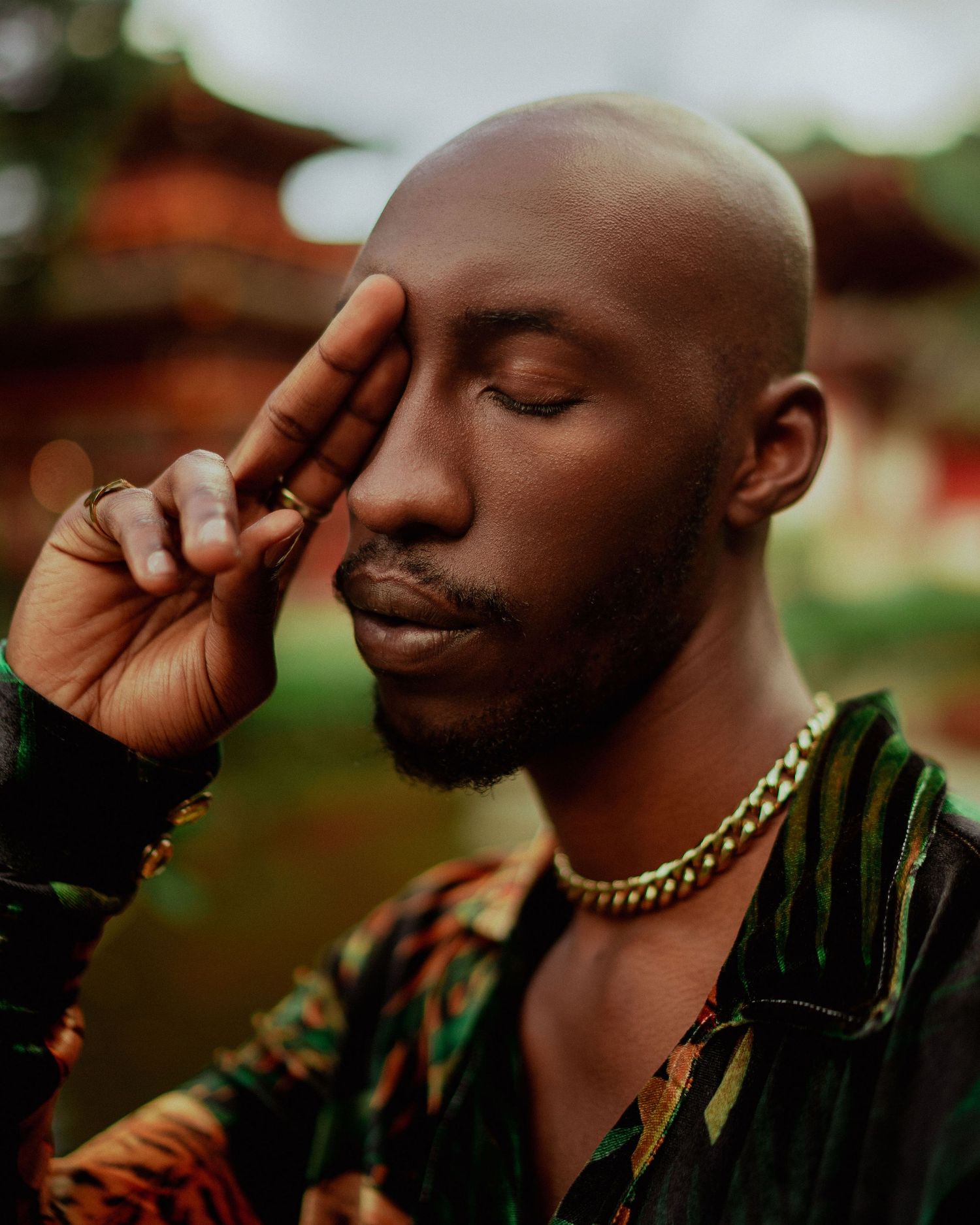 Intimate portrait with closed eyes wearing gold chain necklace and patterned shirt. PZ STUDIO VISUALS