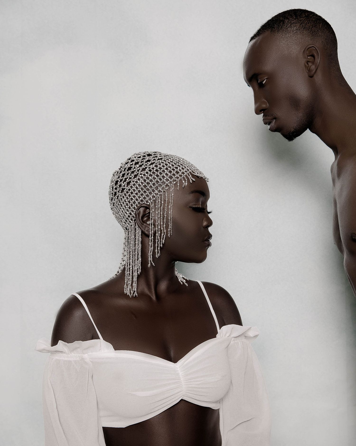 Minimalist fashion portrait series featuring white garments against light background.PZ STUDIO VISUALS