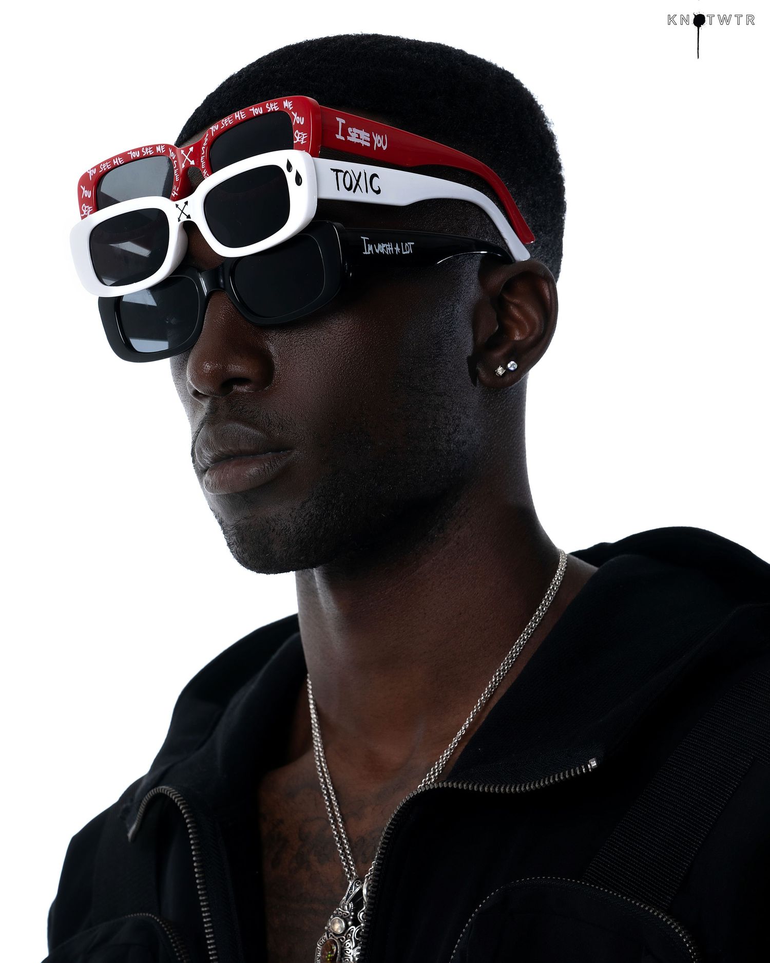 Urban fashion series with stylized sunglasses and black hoodie against white backdrop. PZ STUDIO VISUALS