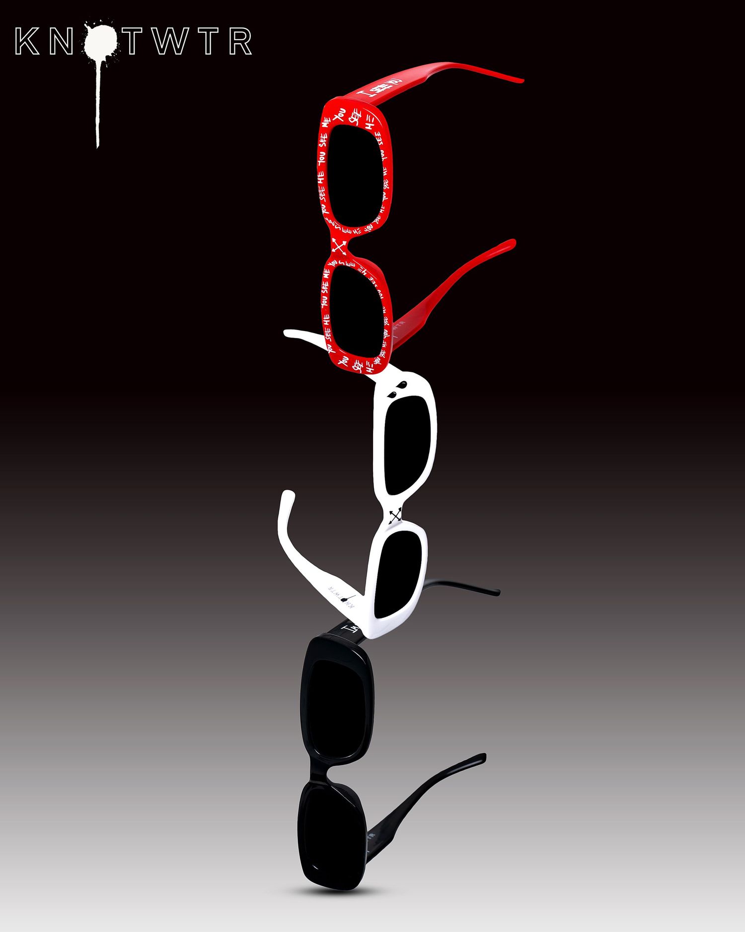 Artistic arrangement of sunglasses stacked vertically in red, white, and black colors against a dark background. PZ VISUALS