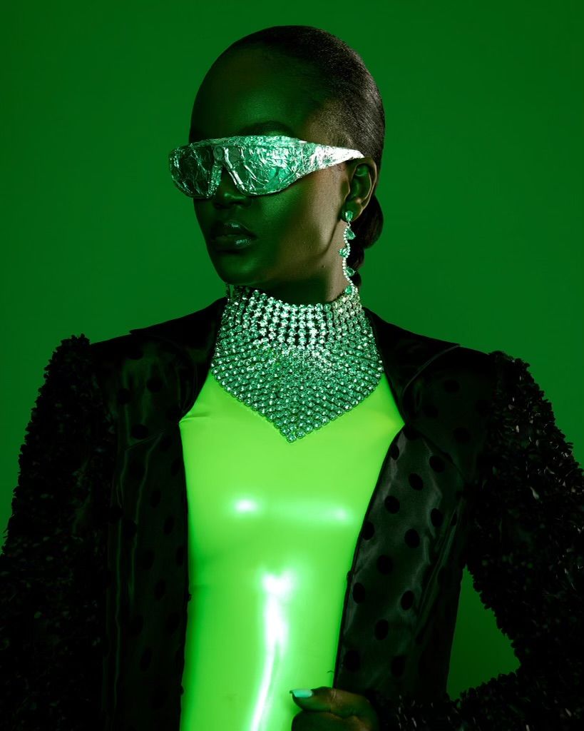 Futuristic fashion portrait with metallic eyewear and crystal choker against green background. PZ STUDIO VISUALS