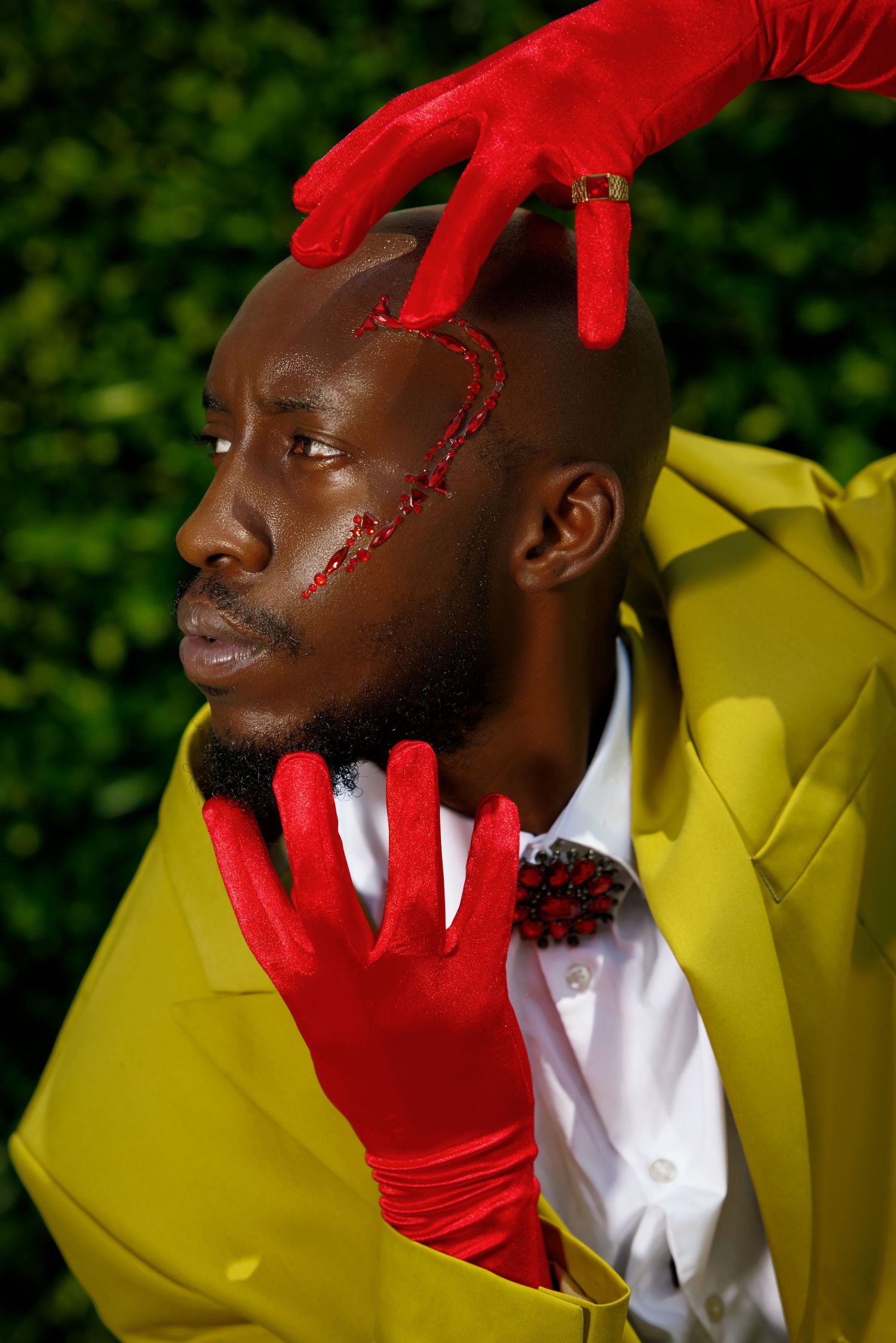 Editorial fashion shot with yellow suit, red gloves, and artistic facial details. PZ STUDIO VISUALS