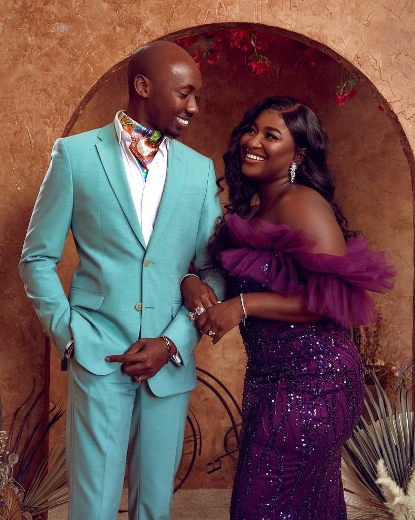 Couple in formal wear posing together, with turquoise suit and purple sparkly dress. PZ STUDIO VISUALS