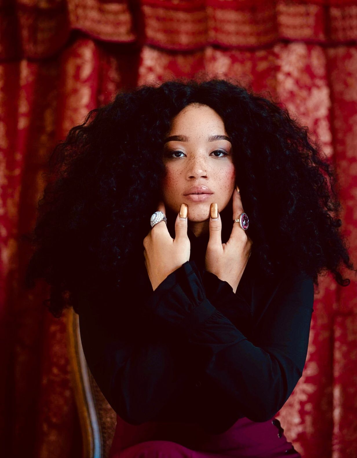 Moody fashion portraits with black outfit against red patterned curtain background. PZ STUDIO VISUALS