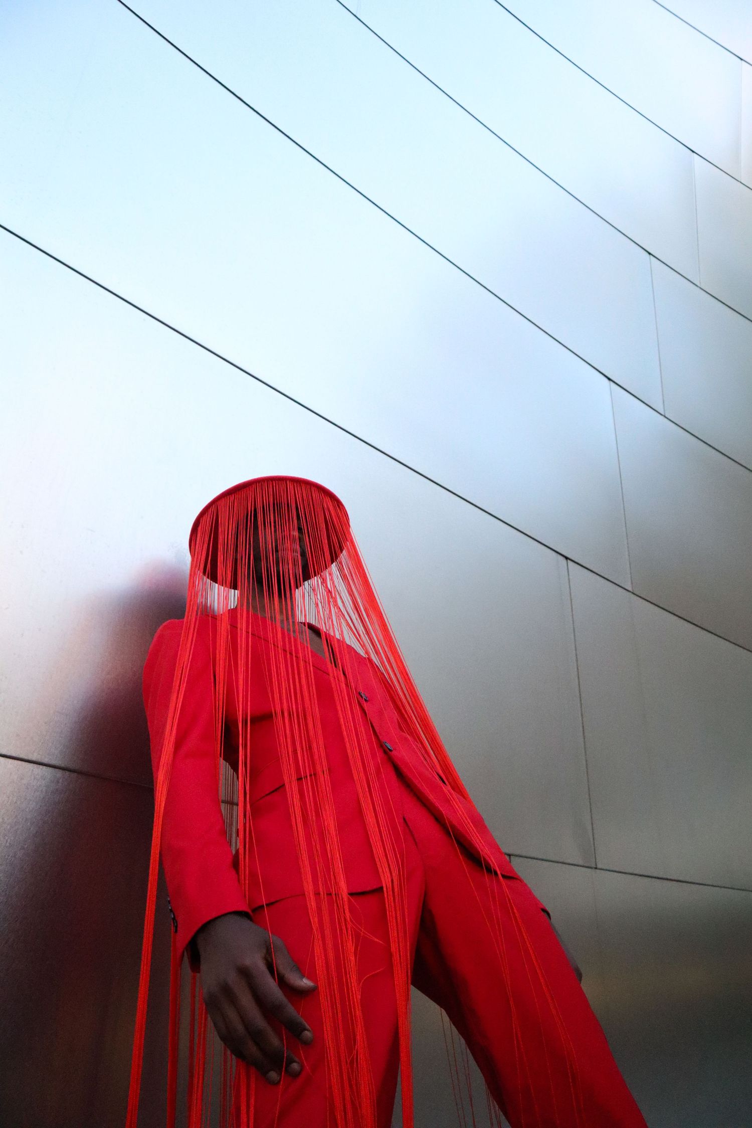 Artistic portrait featuring a striking red veil against a minimalist background.PZ STUDIO VISUALS