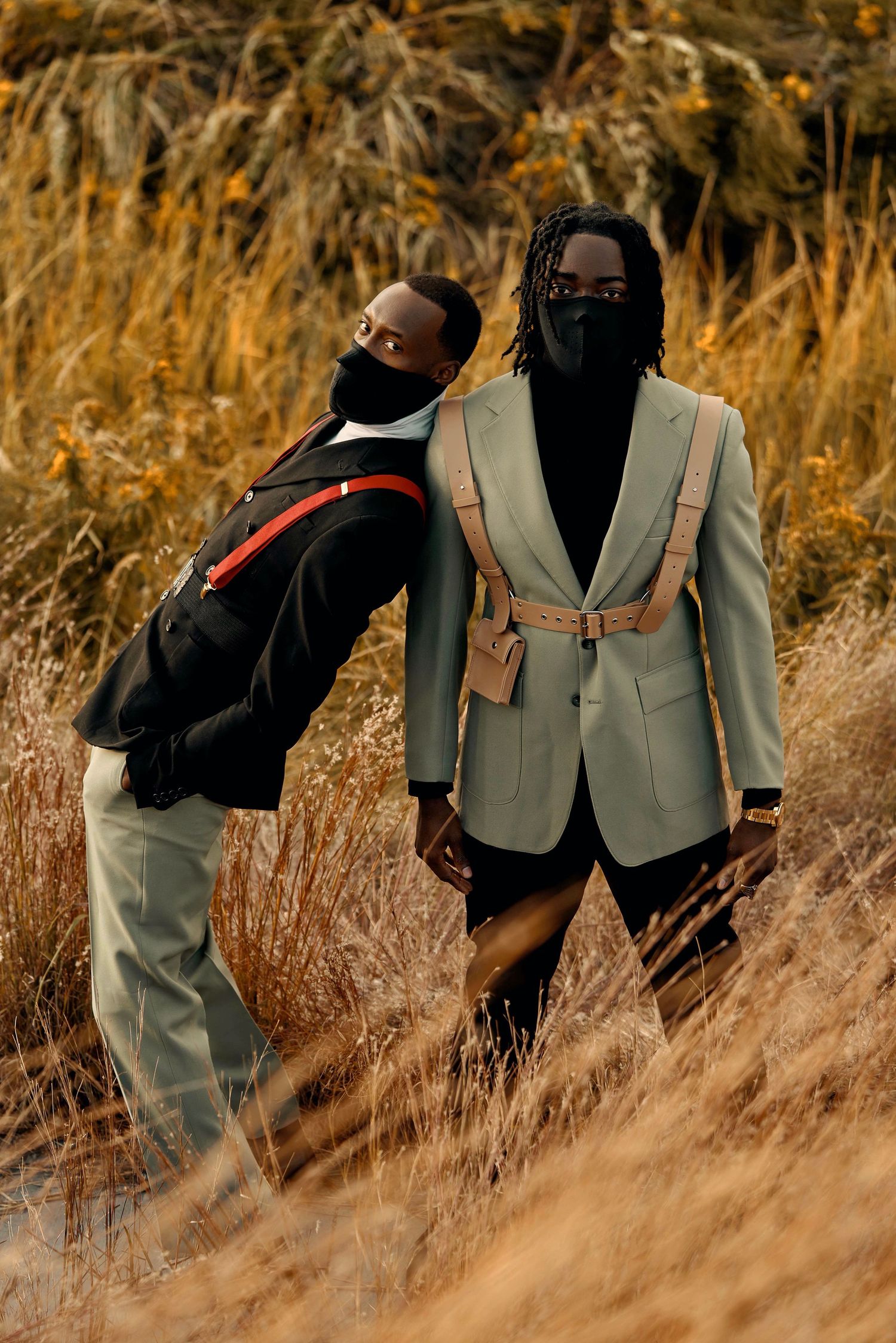 Models in sage green outfits pose among tall grass during golden hour. PZ STUDIO VISUALS