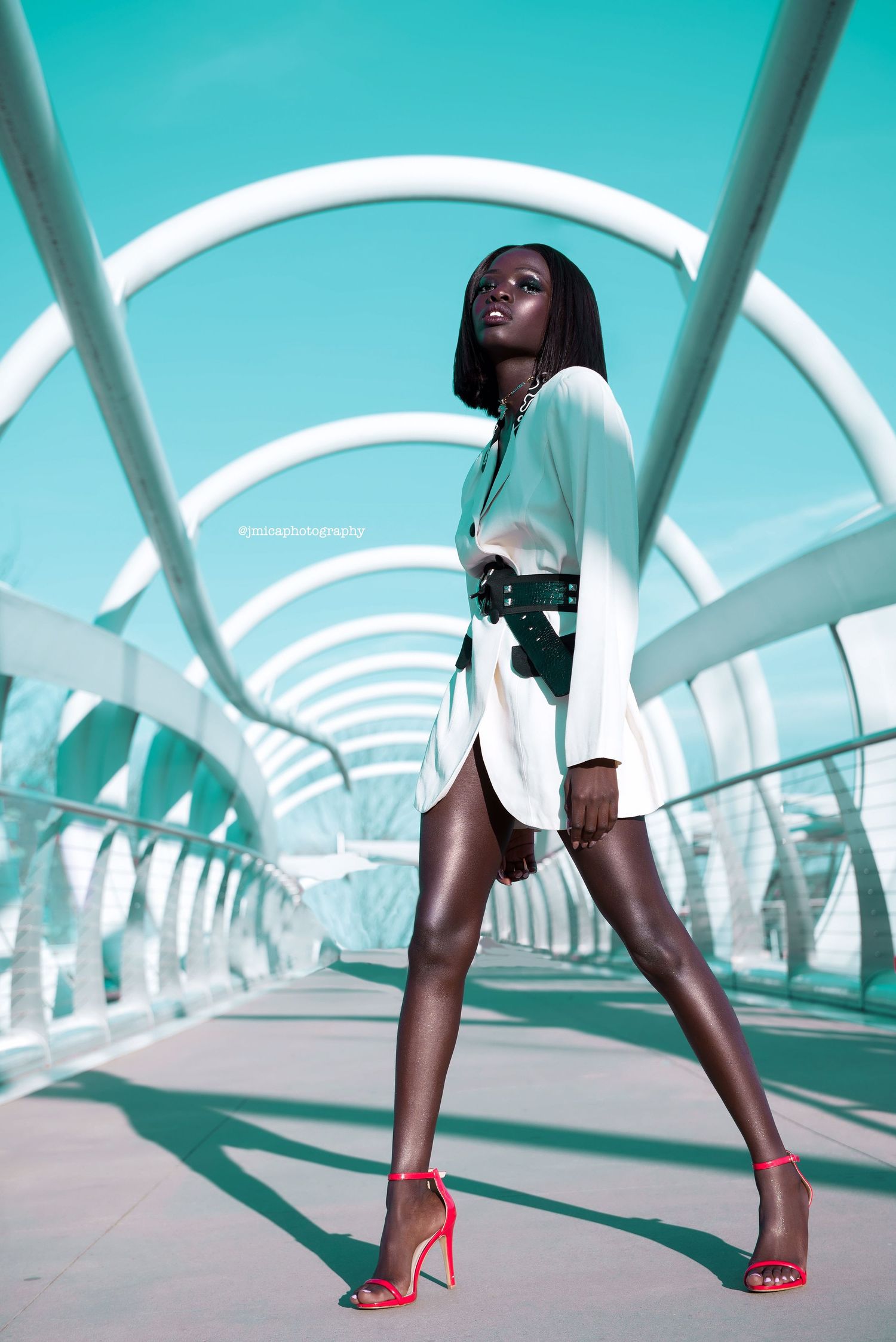 A series of four fashion shots showing red high heels walking through a modern turquoise-lit architectural tunnel. soukenya. PZ STUDIO