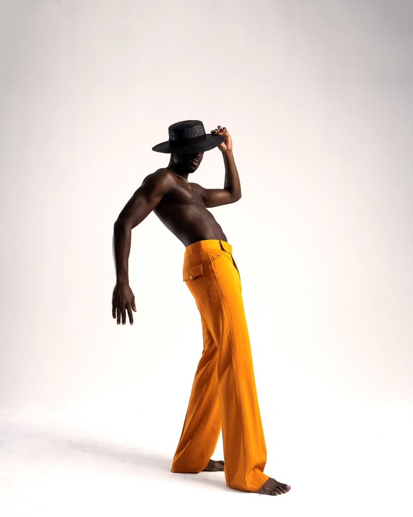 Dynamic movement sequence featuring yellow pants and black hat against white background. Julius Antwi for PZ STUDIO VISUALS