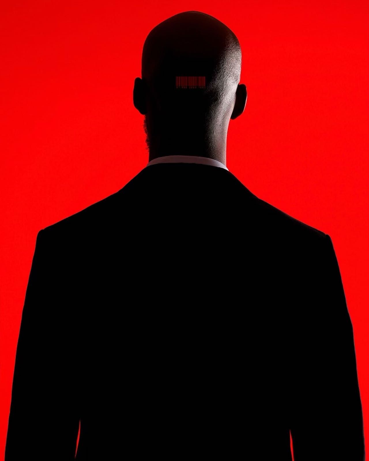 Silhouette of person in suit against vibrant red background. PZ STUDIO VISUALS