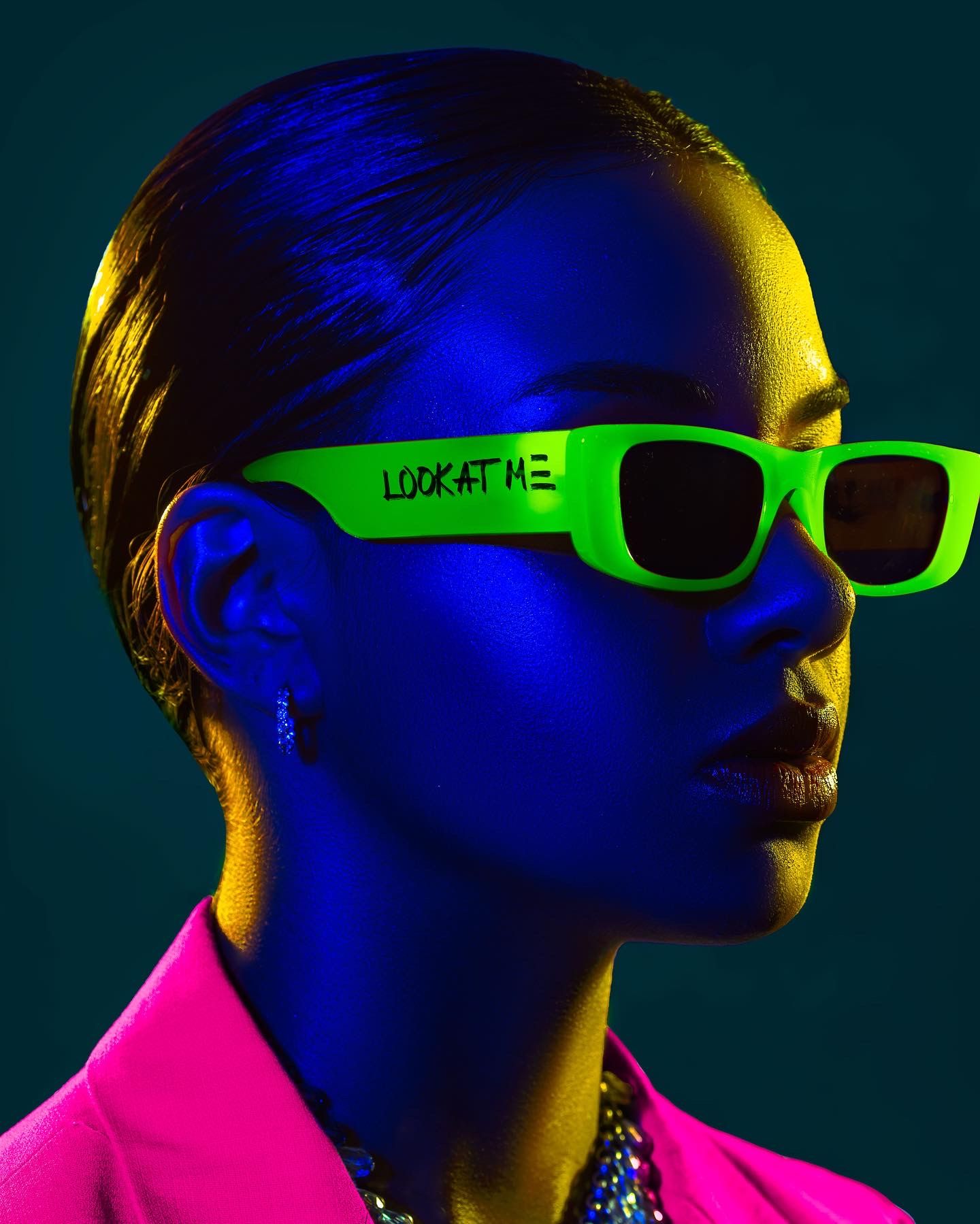 Neon fashion portrait with bright green sunglasses against dark background. PZ STUDIO VISUALS
