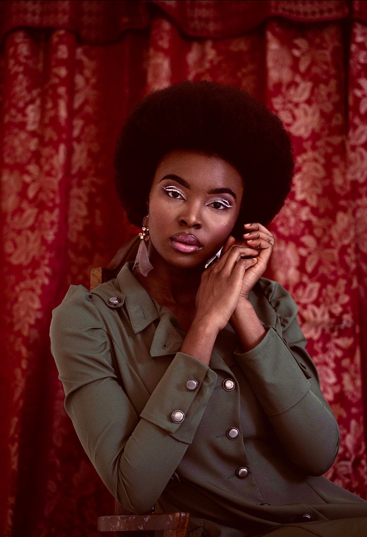 Vintage-inspired fashion portraits with red curtain backdrop and military-style jacket.PZ STUDIO VISUALS