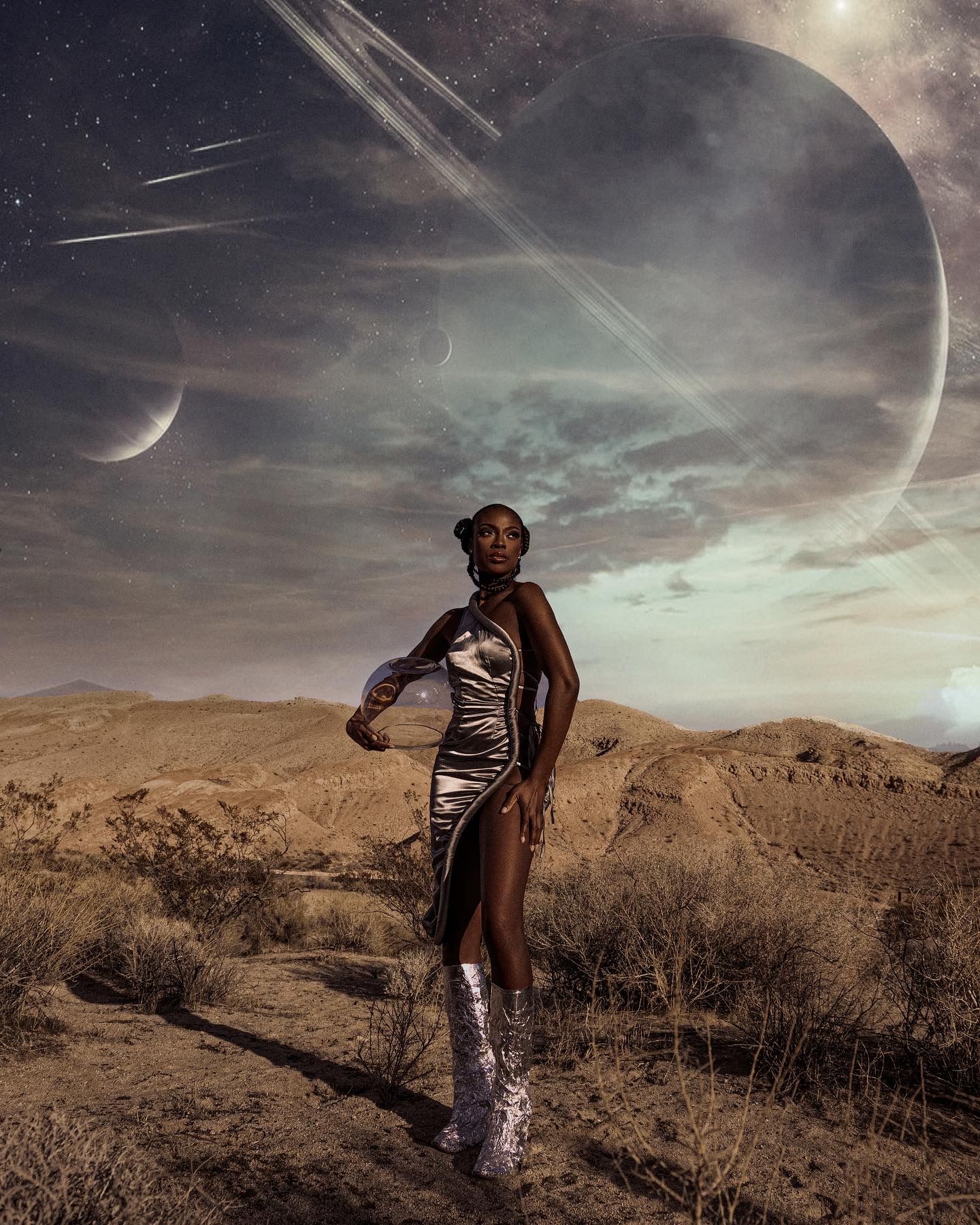 Silhouetted figure in metallic outfit dances across desert landscape under sci-fi sky. PZ STUDIO VISUALS  shot by Tony B