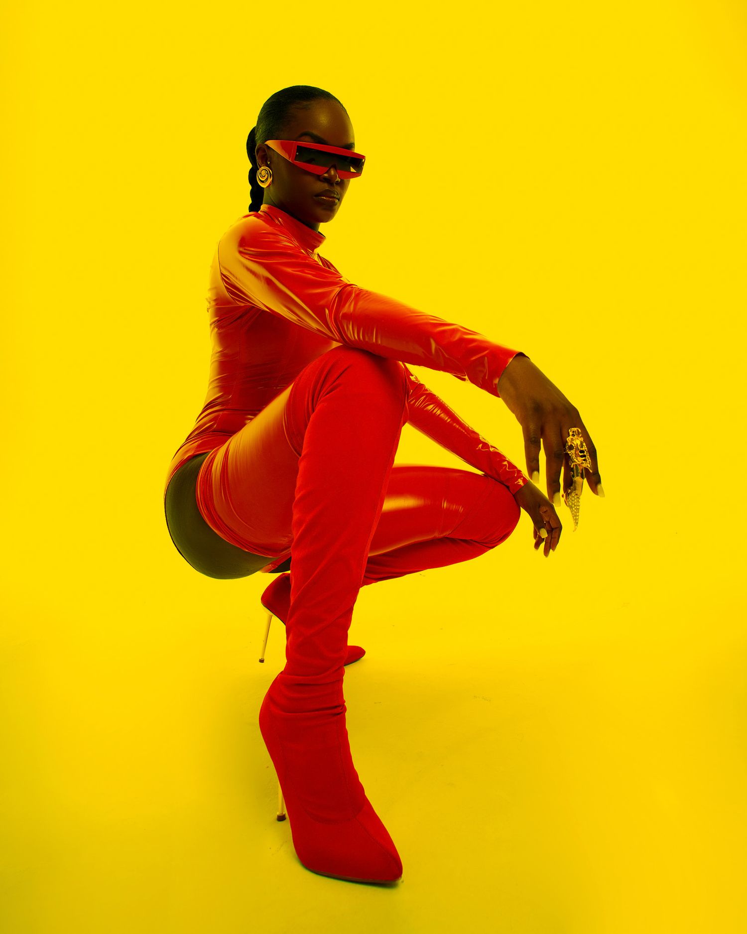 Dancer in red outfit performs dynamic movements against vibrant yellow background. PZ STUDIO VISUALS
