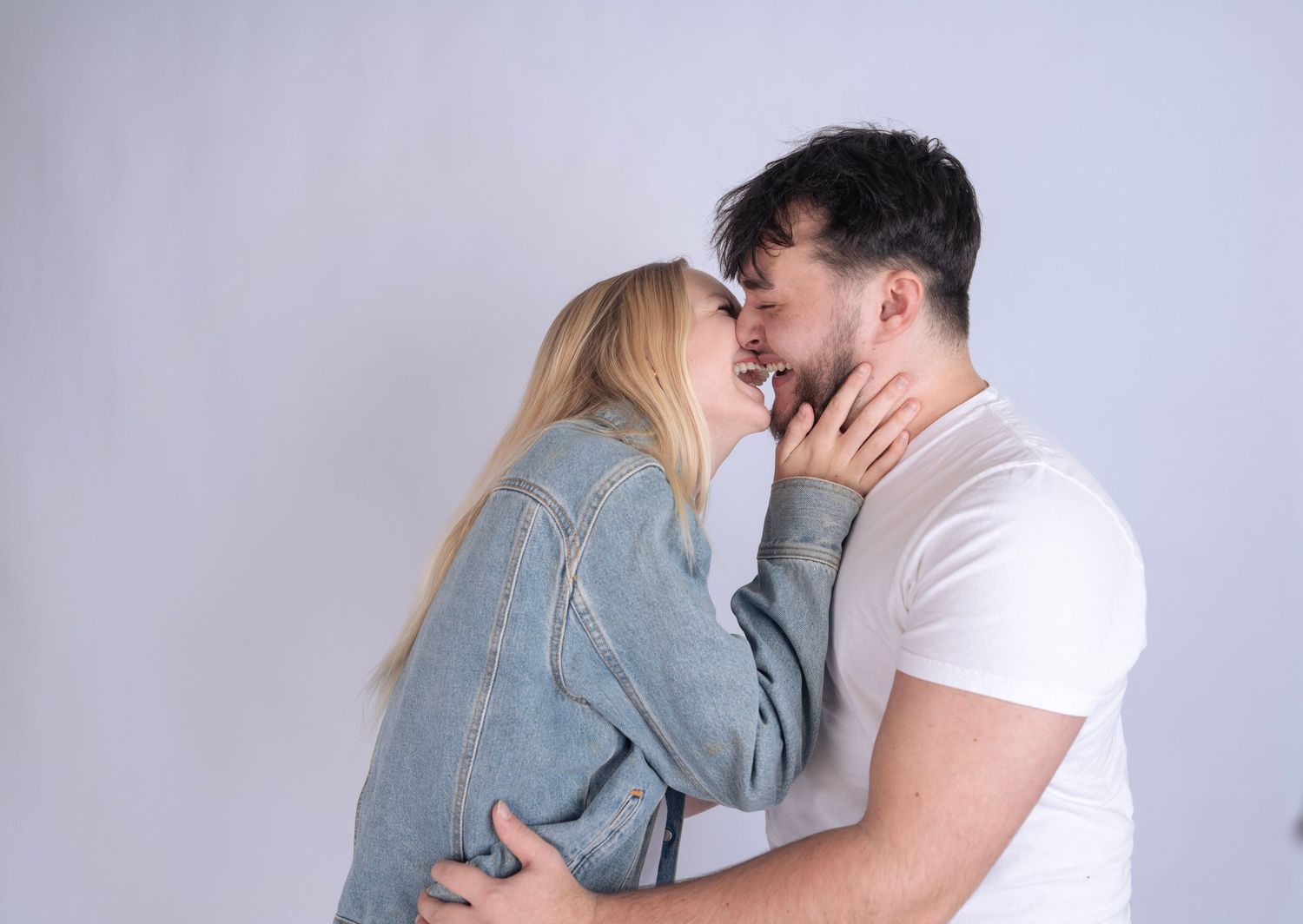 Couple embracing tenderly in romantic studio photoshoot.