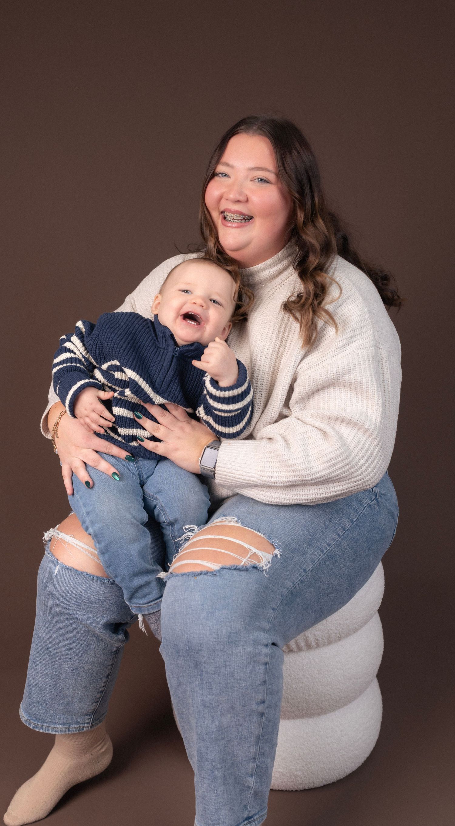 Candid lifestyle portraits showing joyful moments on white chair.