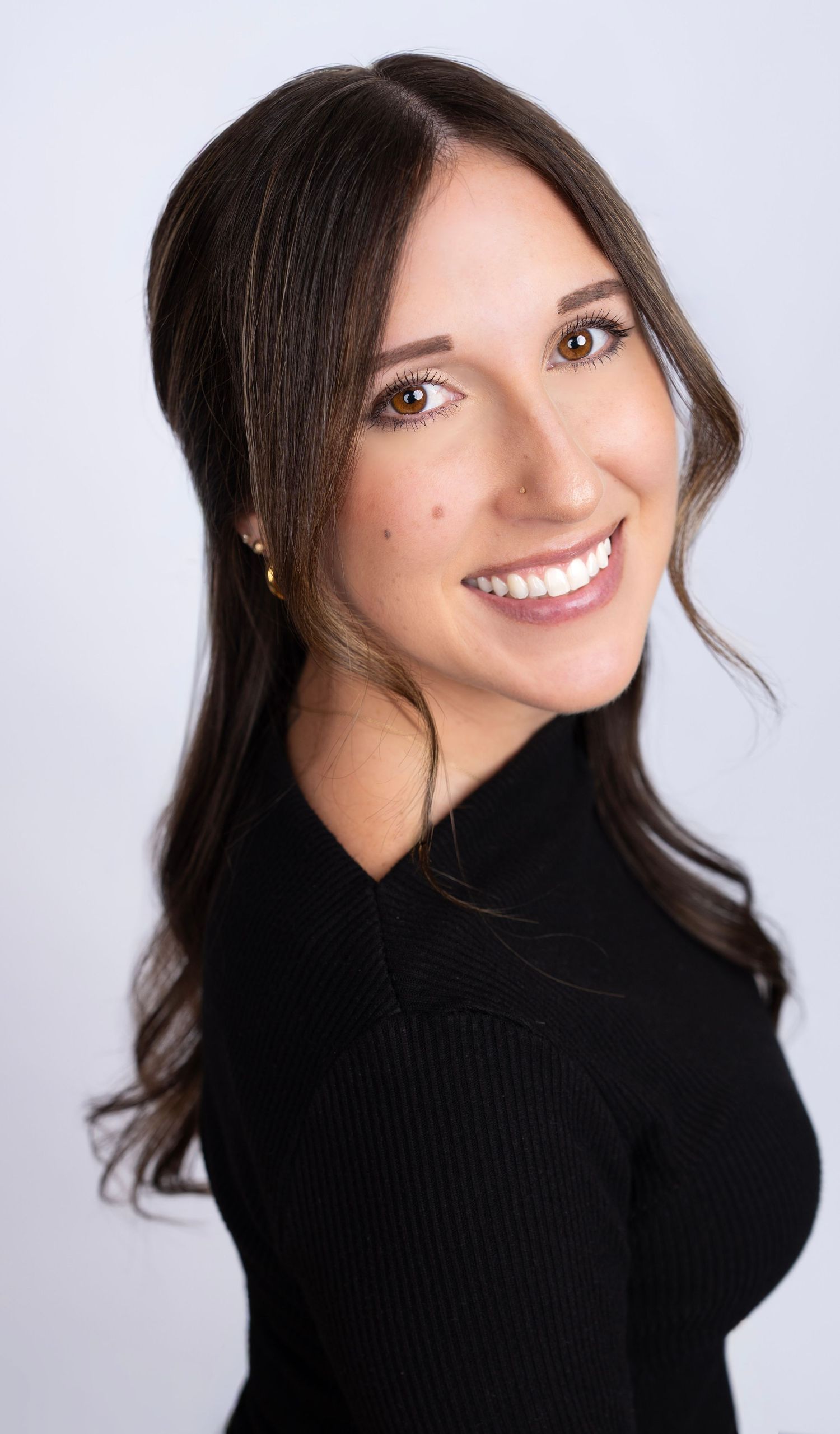 Professional portrait series showing bright smiles and dark sweater against light background.