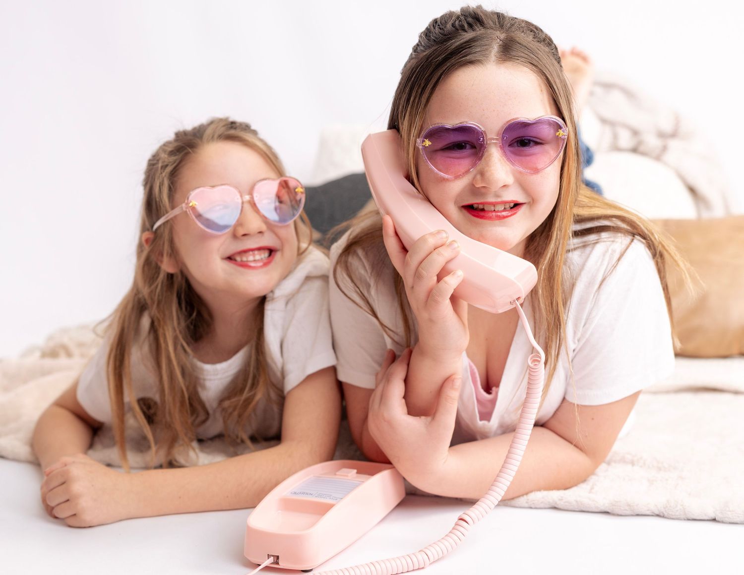 People relaxing on white background wearing casual outfits and sunglasses.