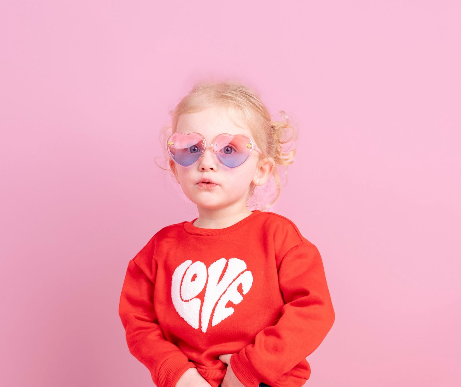 Series of photos showing child in red sweater against pink background.