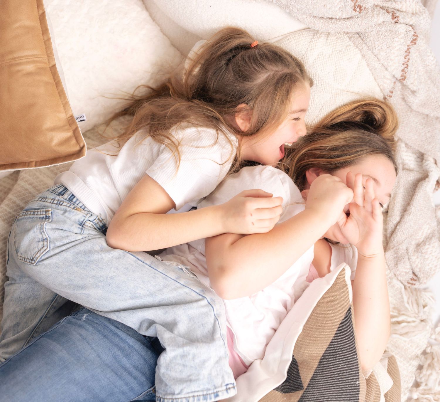 Relaxed poses on cream colored bedding showing casual lifestyle moments.