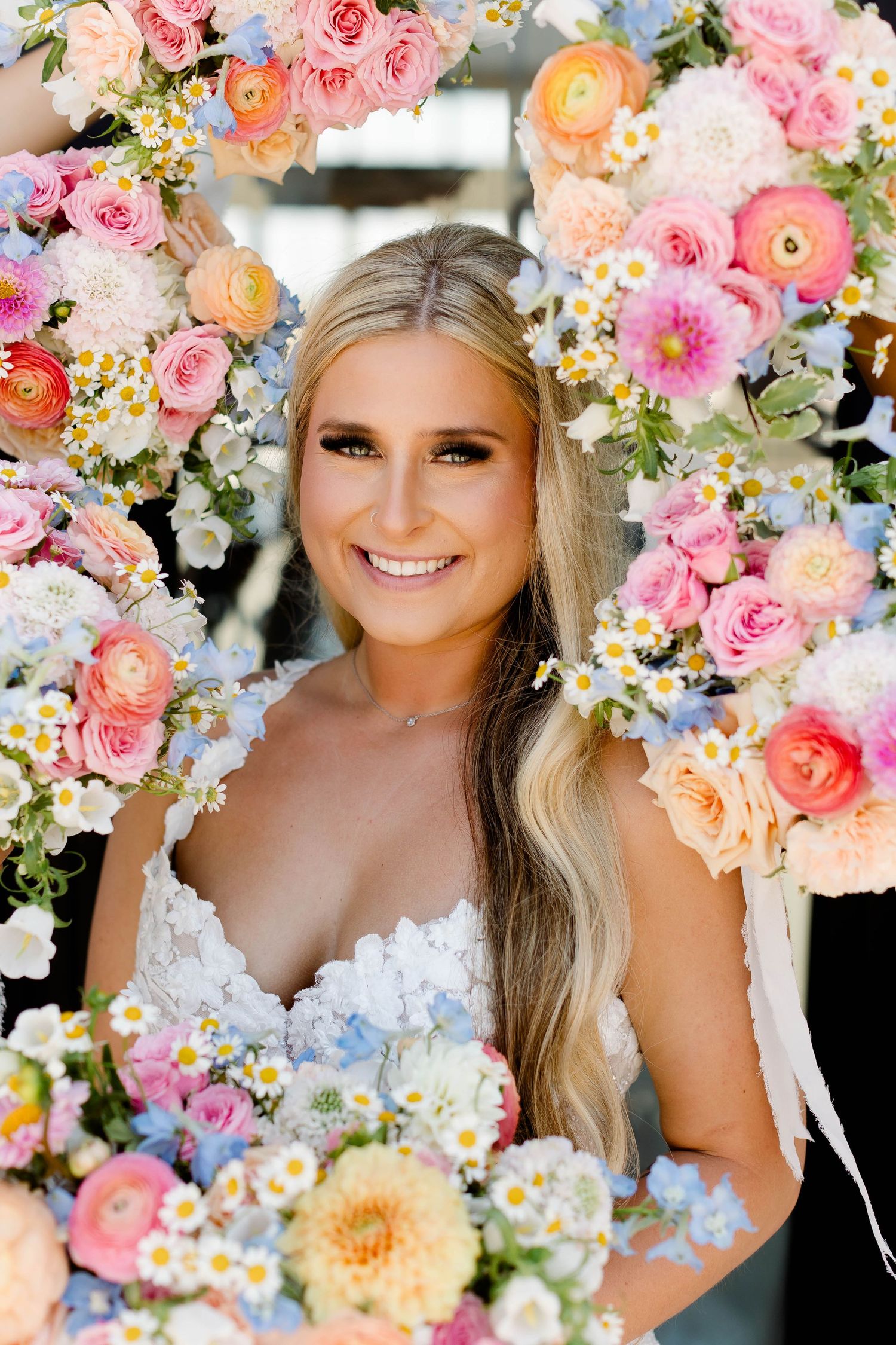 Stunning floral crown with pink roses and mixed blooms creates romantic bridal accessory.